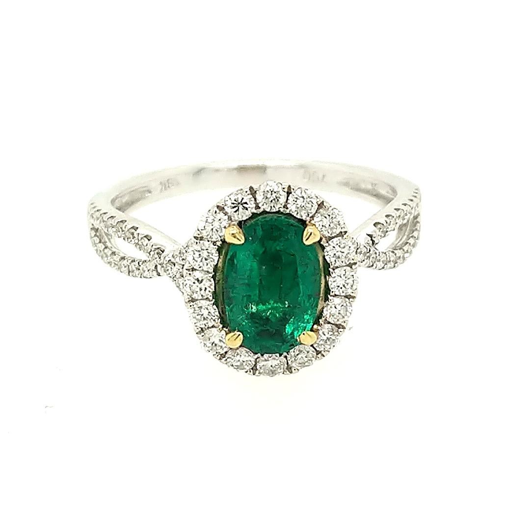 This ring is crafted in 18k yellow and white gold featuring (1) oval emerald weighing .88carat and (60) round diamonds weighing .50cttw. The ring is a size 6 3/4.