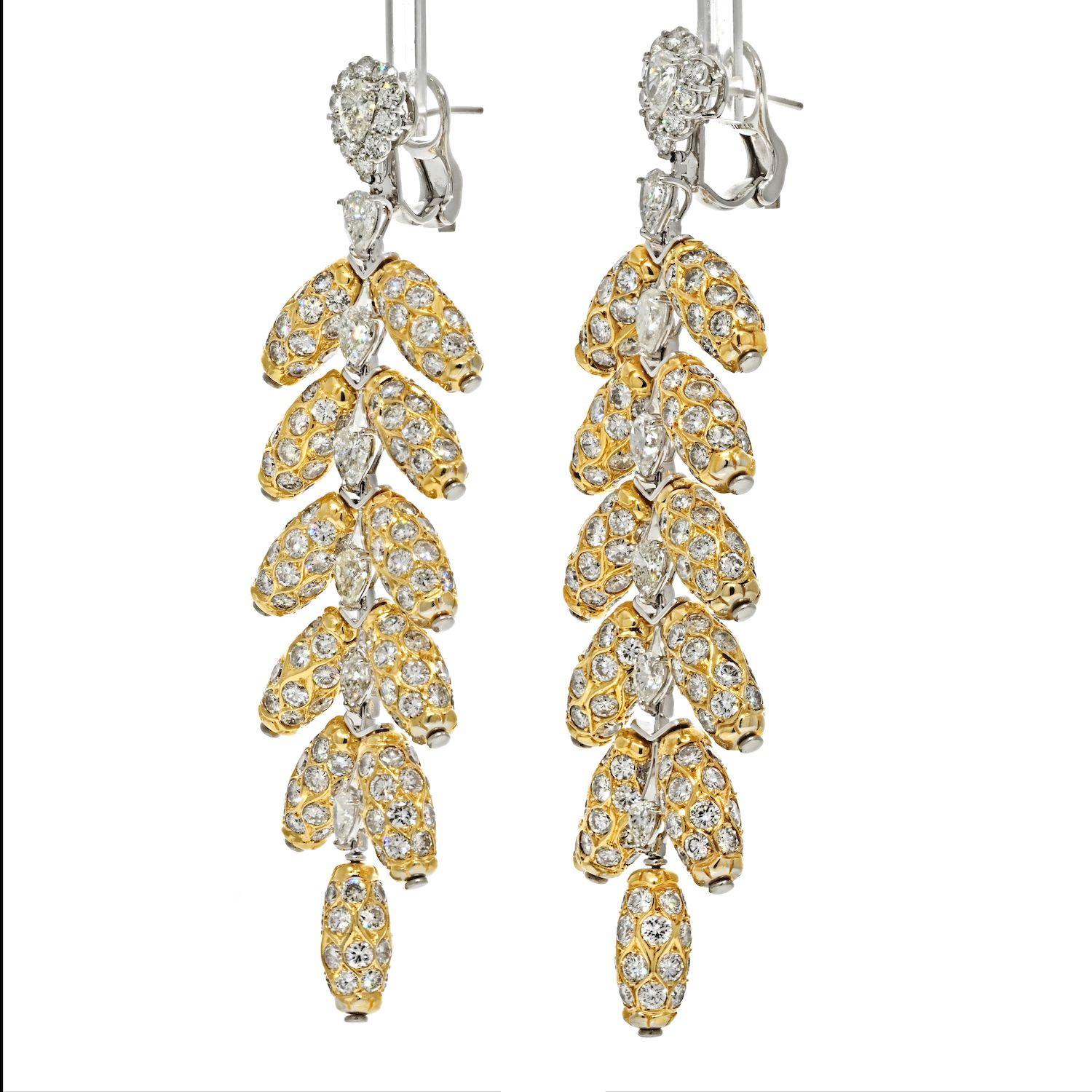 From our Estate Collection. A free-spirited creation dramatic pendant feather earrings capture the beauty and all the glam of the peacock's feather motif in intricately detailed 18K yellow gold diamond jewel. These earrings feature 2 diamonds of