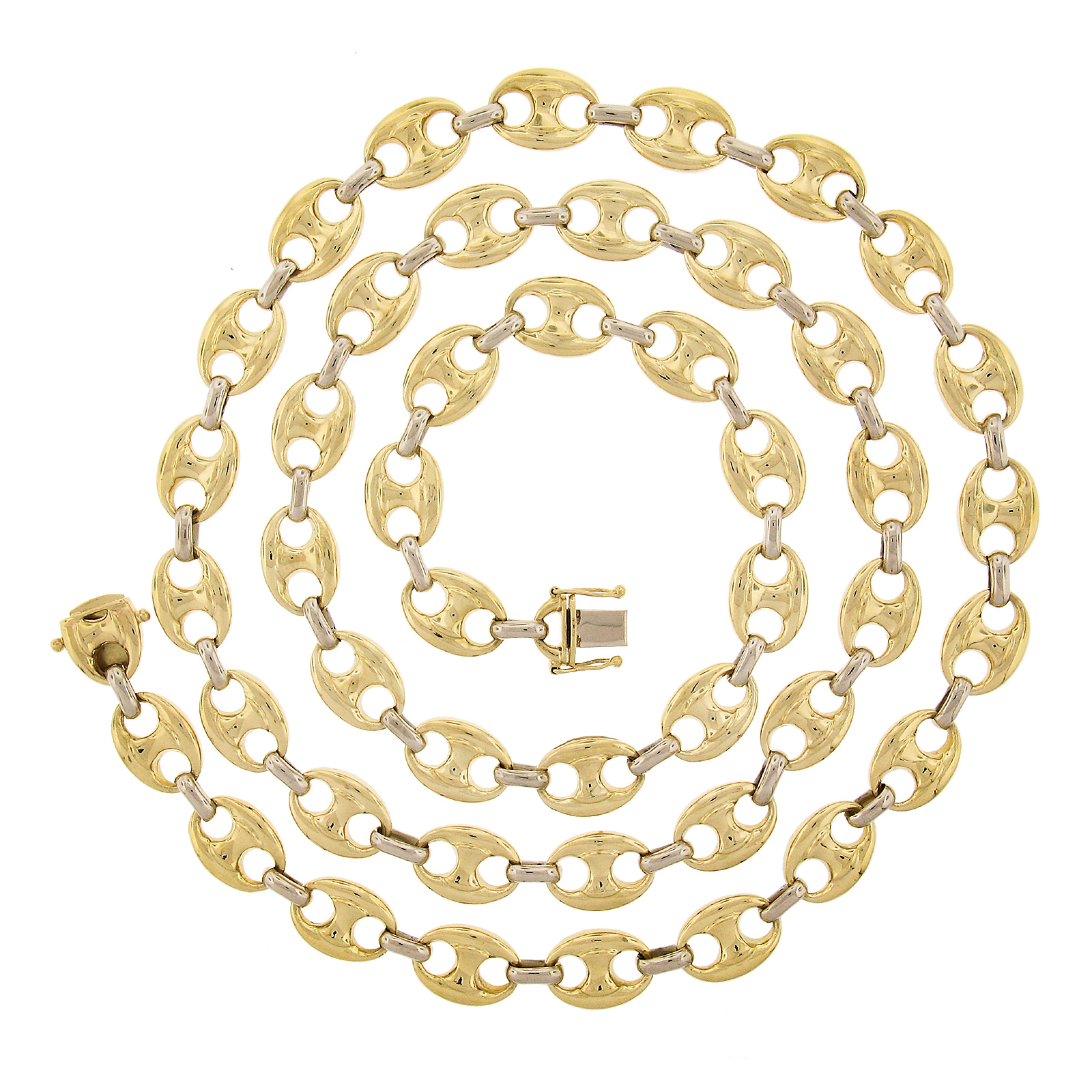 This beautiful and substantial mariner link chain necklace was very well crafted from solid 18k yellow gold with white gold connecting oval links throughout. This 11.6mm wide necklace has a wonderful high-polished finish with a super bold look