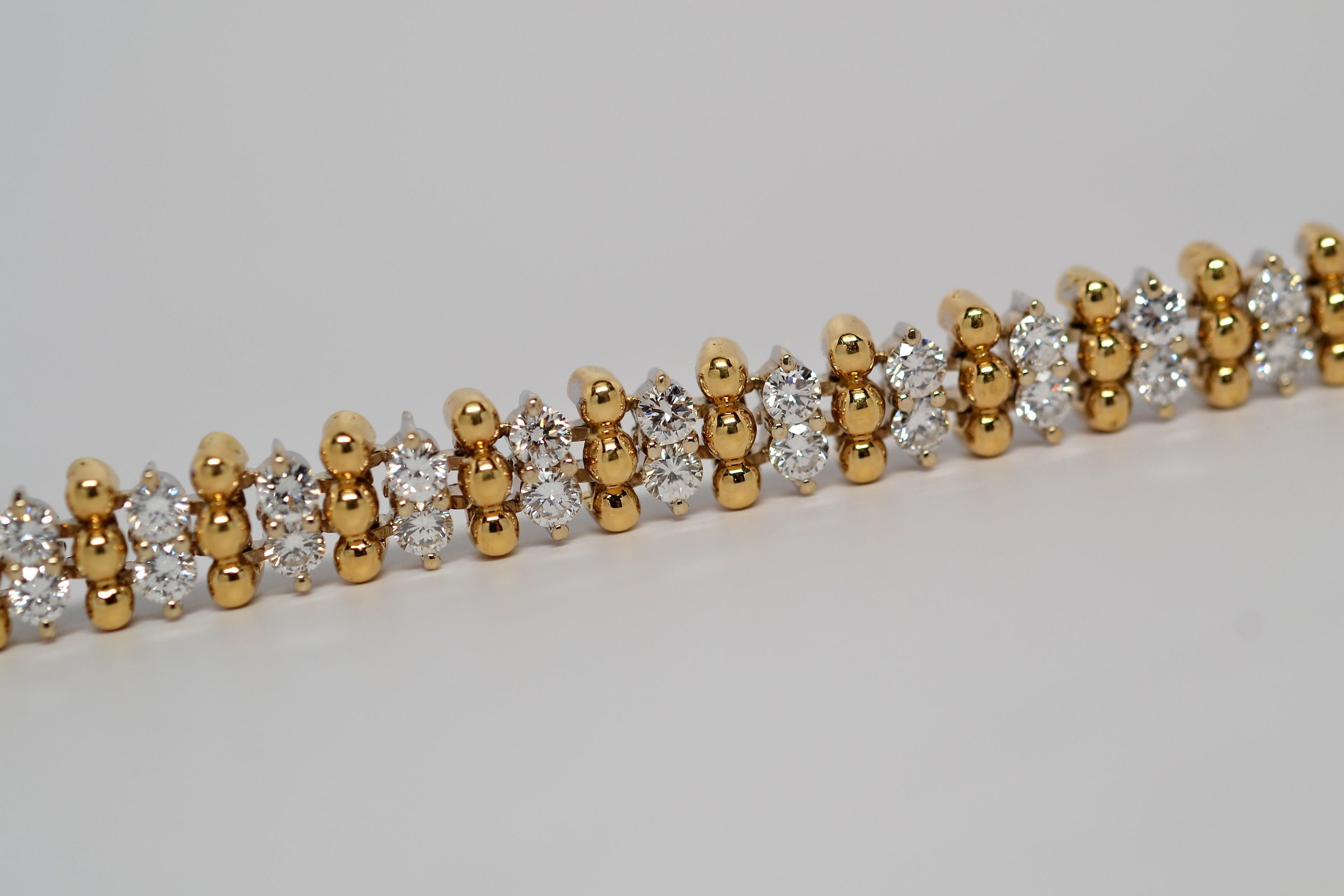 A fun and vibrant bracelet set in two tone 18K Yellow Gold and White Gold with Round Brilliant Cut Diamonds. This particular layout is an alternating pattern of gold beads and diamonds with a secure push button clasp and secondary lock. 
Sixty Round