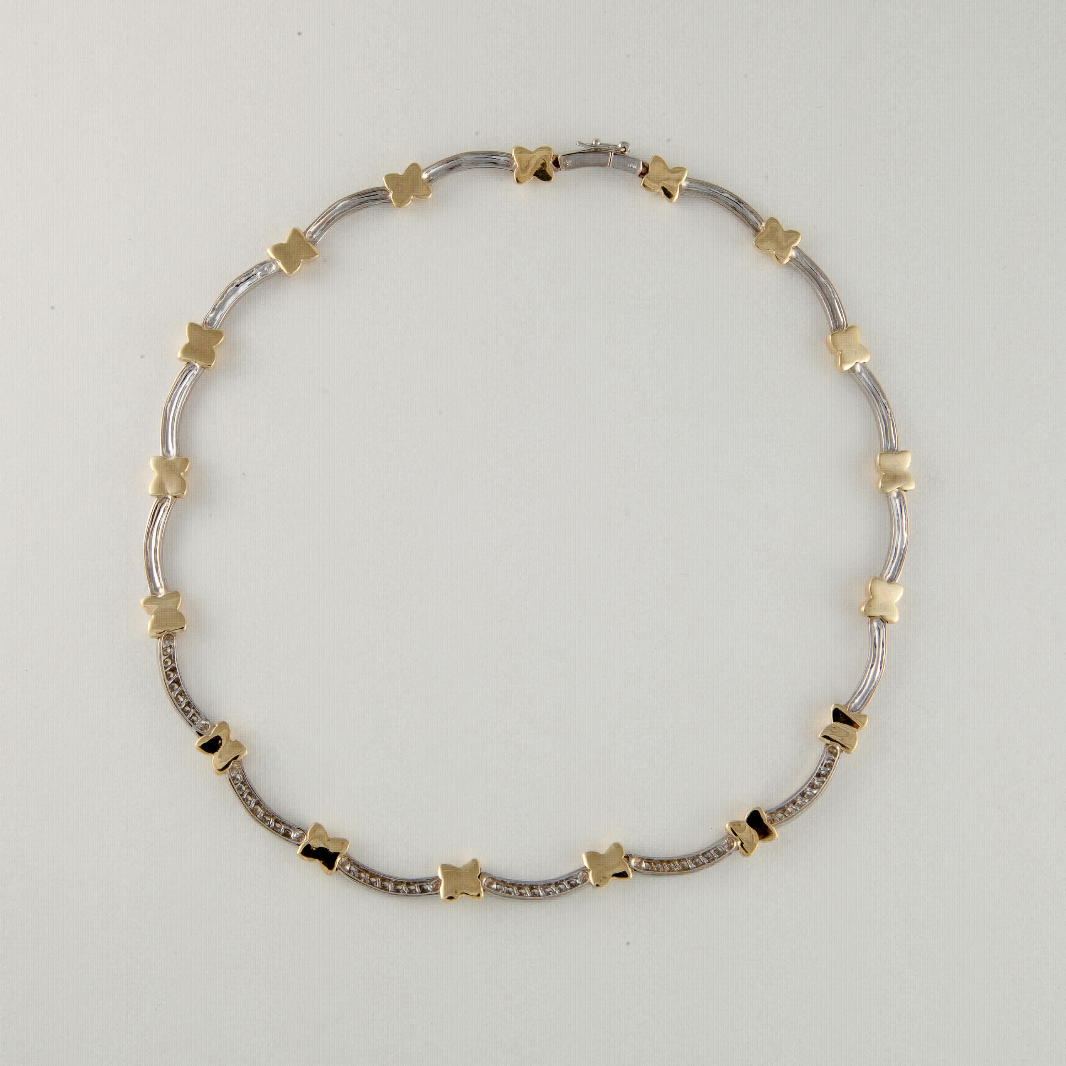 18K two-tone gold scalloped necklace with diamonds.  There are 42 round diamonds totaling 1.75 carats; G-H color and VS-SI clarity.  The necklace measures 17 inches long and is 1/4 inches wide.  