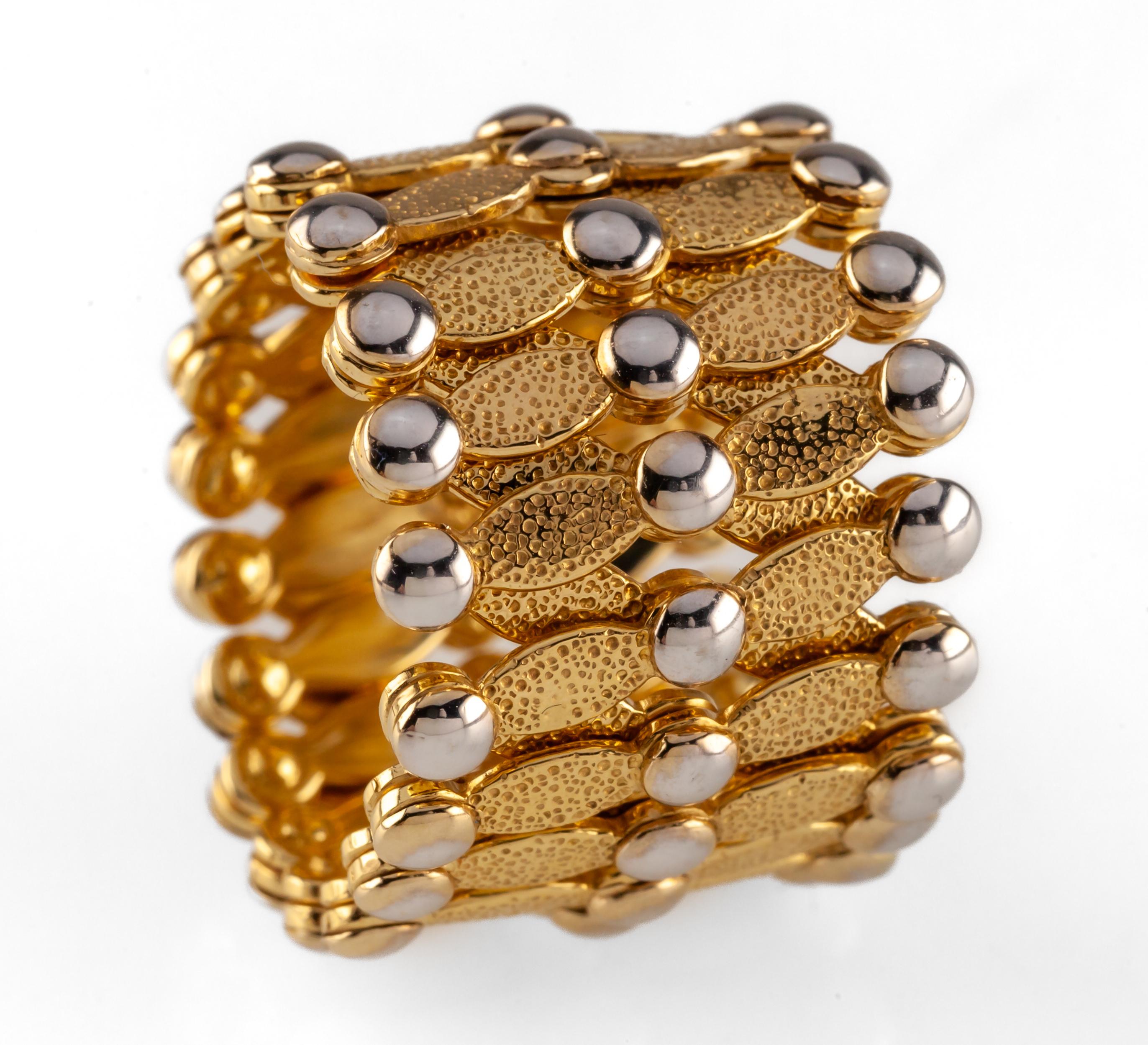 18k Two Tone Gold Expansion Ring/Bangle Bracelet by The Gold Market Firenze

Gorgeous, unique expansion bangle bracelet
Expansion design collapses into a ring and out into a bangle
Width of design = appx 17 mm
Total Mass = 21.7 grams
Includes