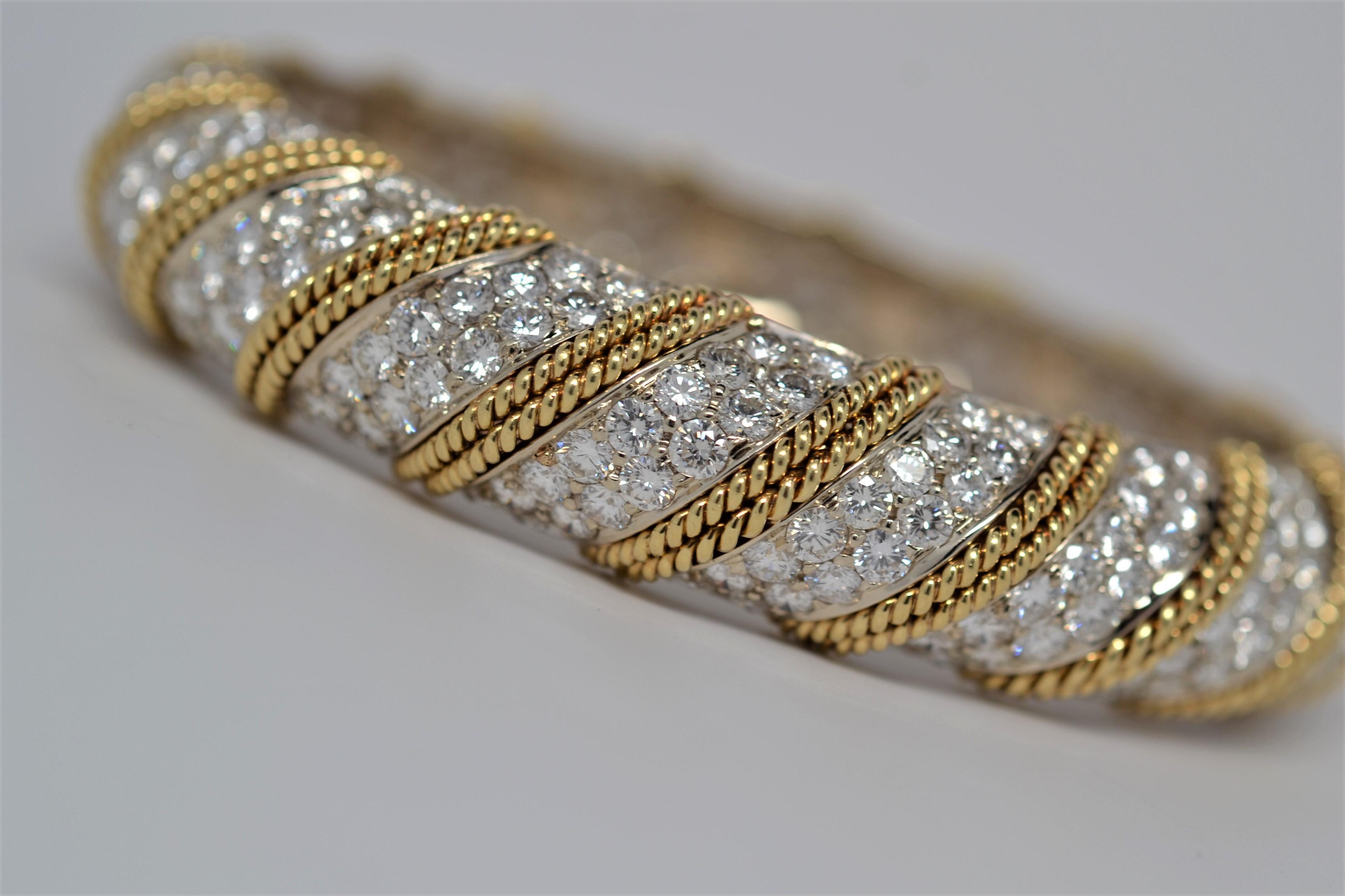 Finely made ladies' Diamond Bangle Bracelet set in 18K Yellow Gold and White Gold. Two-hundred and ninety-two Round Brilliant Cut Diamonds are hand set all around the bangle bracelet with a total weight of 18.25ct. The bangle is a braided design