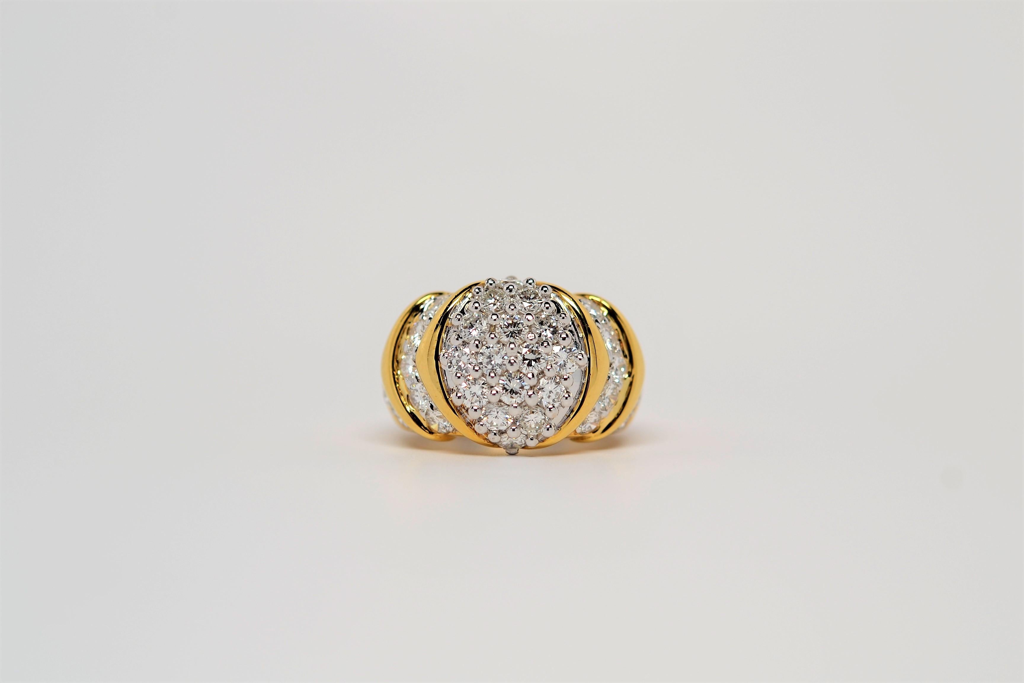A large, statement ring with a two-tone gold layout set in 18K. The ring is made with an 18K Yellow Gold shank and 18K White Gold custom baskets and shared prongs to set the diamonds. 
Thirty six Round Brilliant Cut Diamonds weigh 2.89ct. Diamond