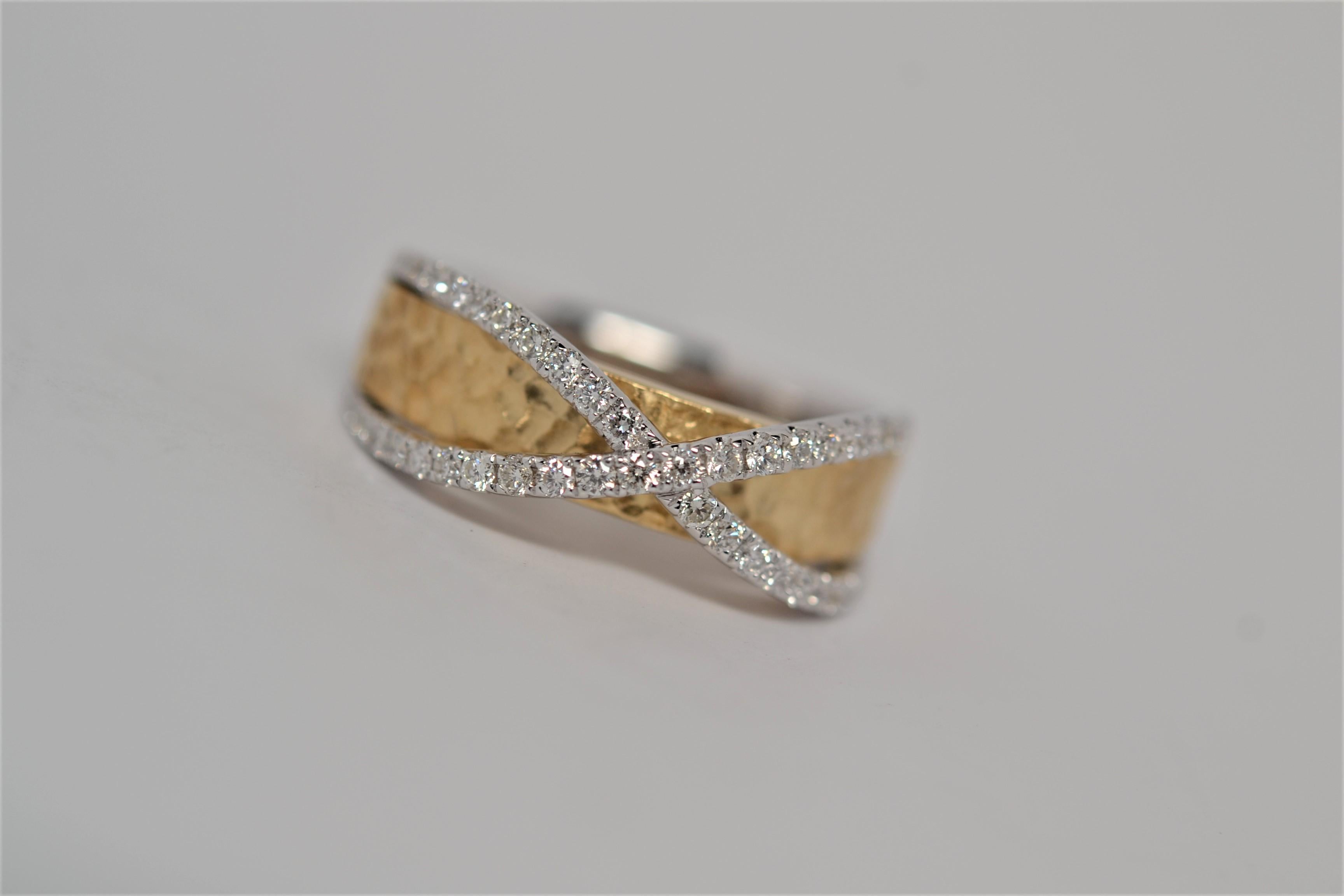 A well made and comfortable ladies' ring, perfectly suited for everyday. Made in 18K Two Tone gold with a white gold criss cross shank and yellow gold center with a hammered finish. A total of fifty four Round Brilliant Cut Diamonds weigh 0.50ct,