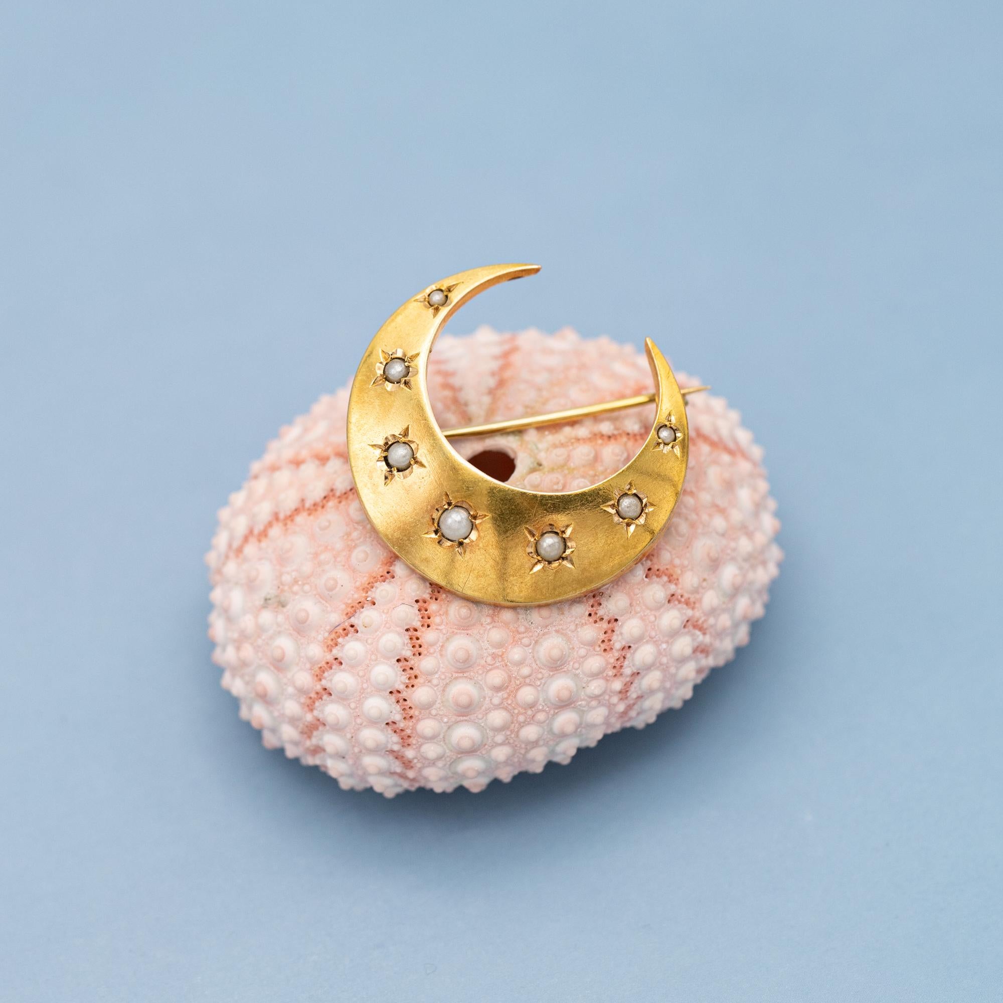 We are happy to introduce you to this work of art from the Napoleon III period during the late 19th century, also known as the late Victorian period. This celestial themed collar brooch is crafted 18 Karat solid gold and features stunning half seed