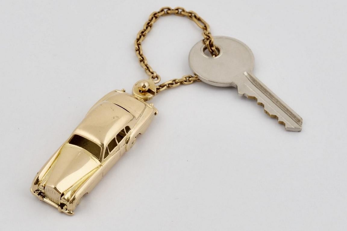 Vintage Cartier 18k Rolls Royce keychain with moveable wheels.  Perhaps made to order, with a wonderful 'trailer hitch' link for the key chain, or wear it as a pendant or displayed as an Objet d’Art and Vertu. 24 grams of 18k gold.  Marked 