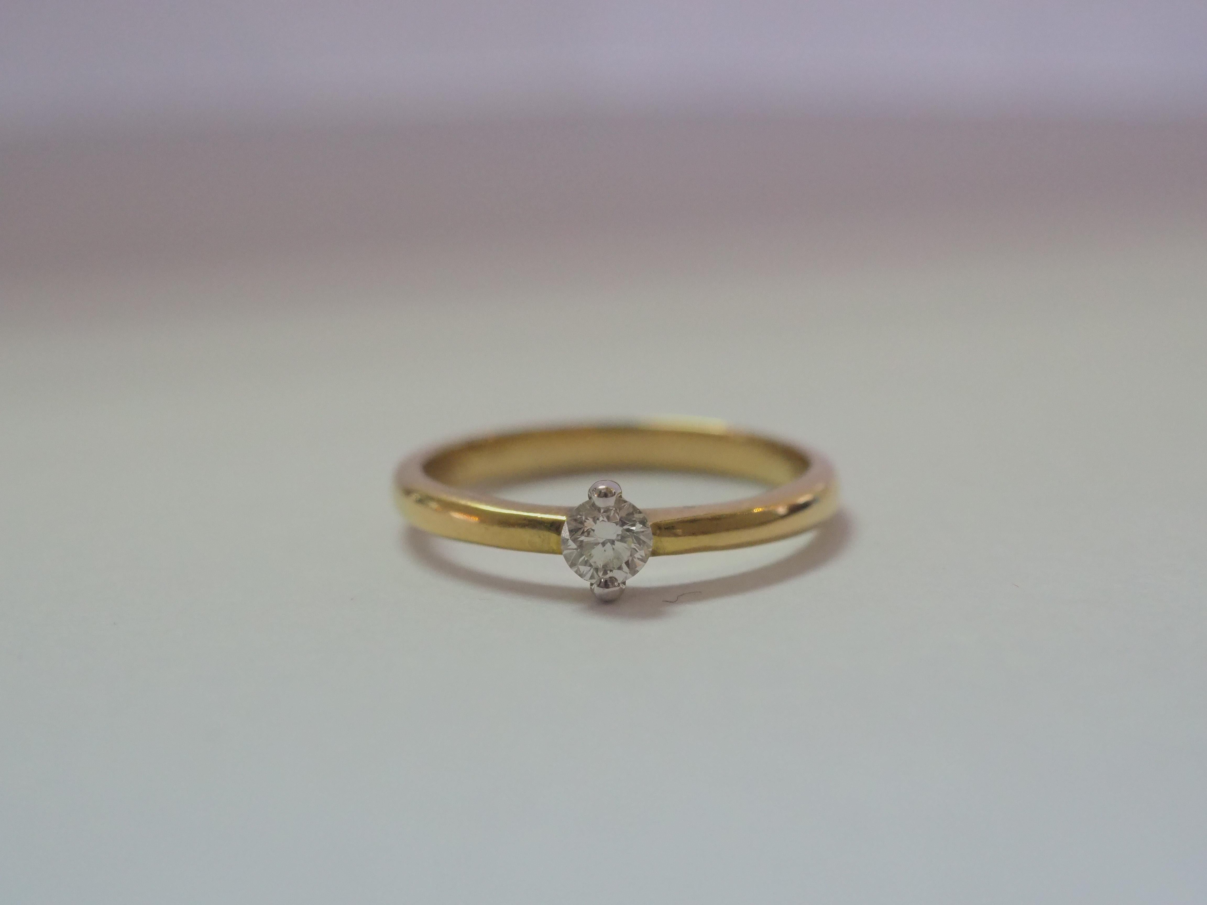 This beautiful solitaire engagement ring boasts a very stunning 0.20 carats VS1-VS2 D color diamond as the main stone! The ring looks dainty but the shank is actually solid. The quality mounting with timeless solitaire design. This ring is perfect