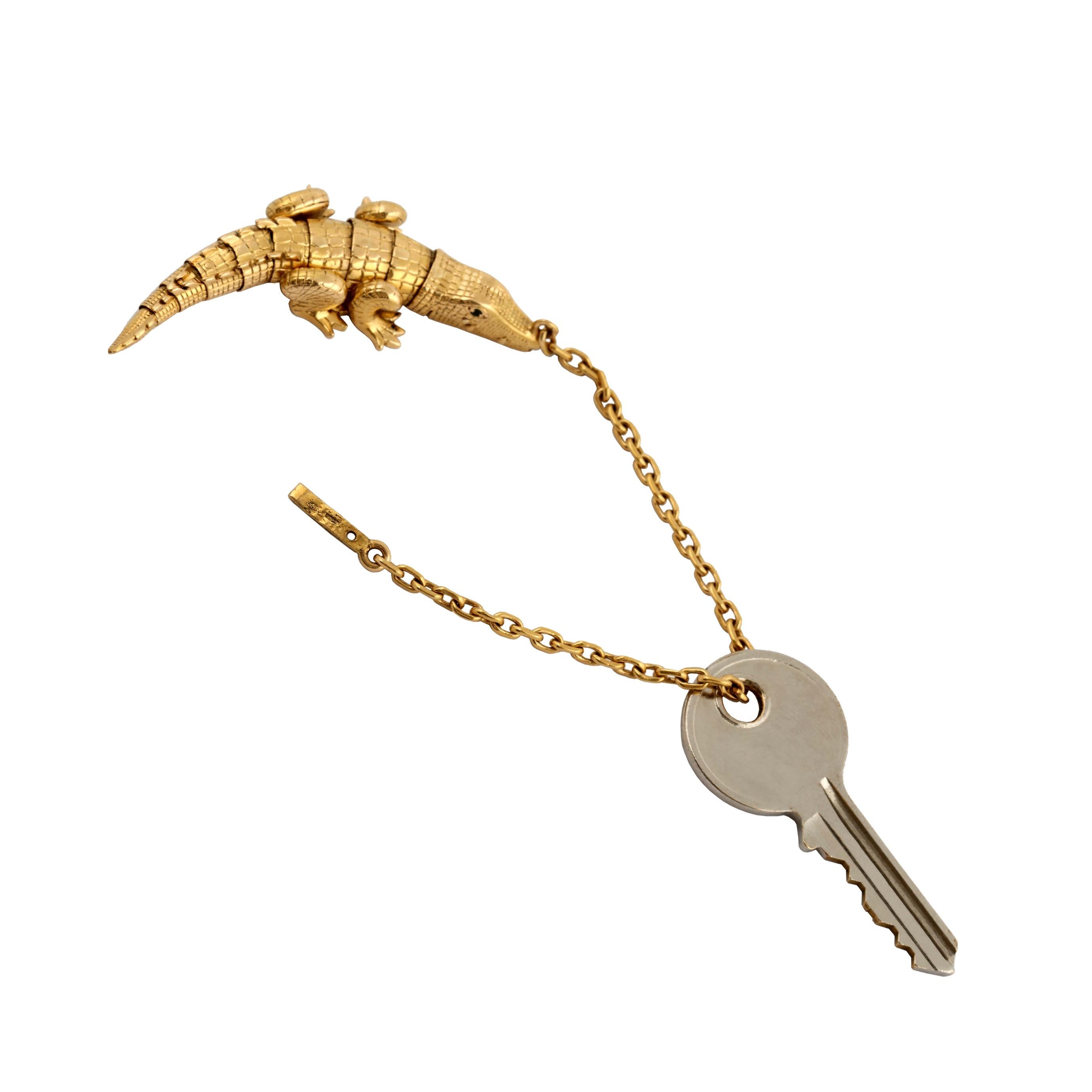  Vintage Tiffany 18k Alligator key chain with tiny emerald eyes.  A very unusual and time-consuming fabrication and design as the body of the Alligator is fully articulated with eleven separate, moveable elements.  Pull the chain through to the