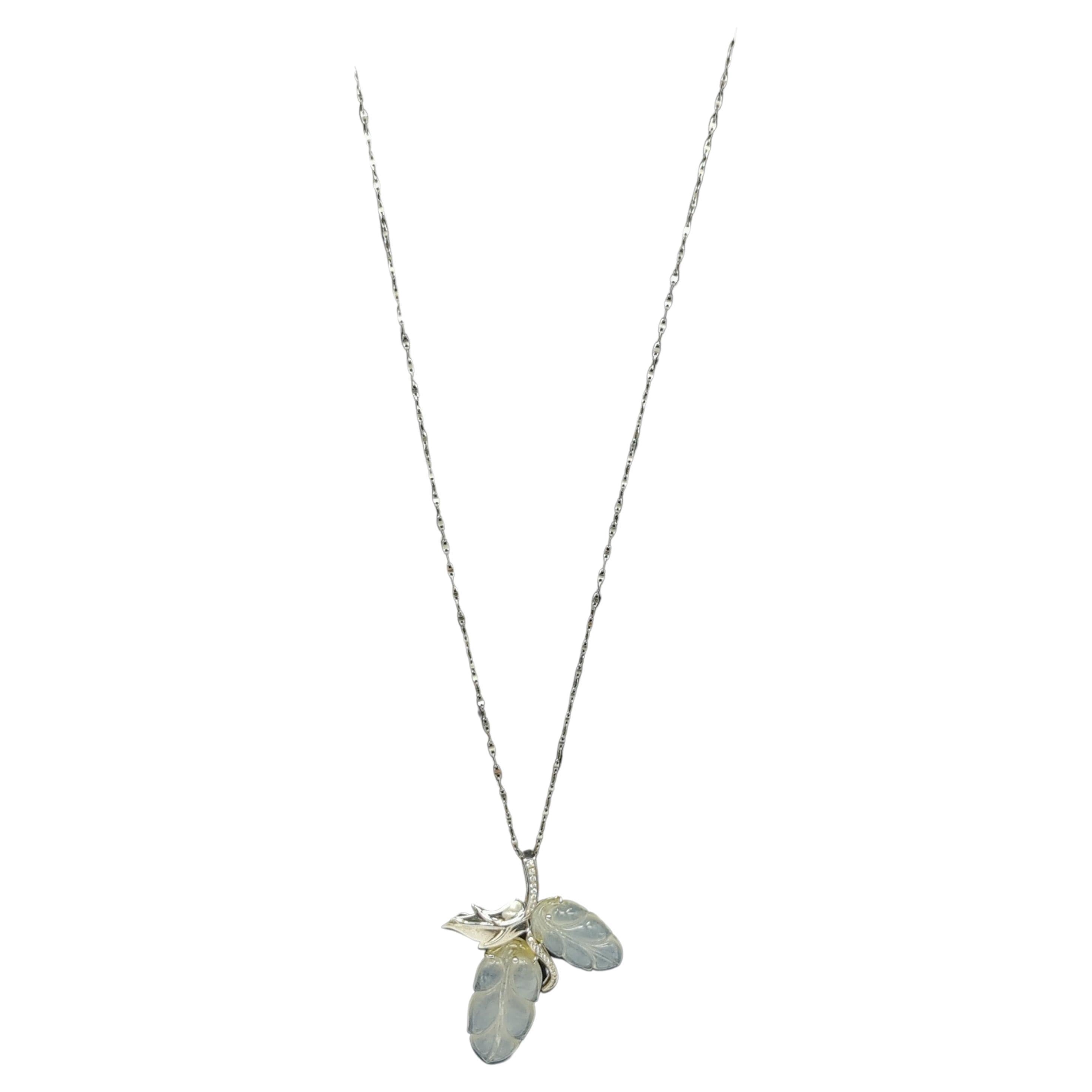 This elegant ladies' pendant is a masterful blend of craftsmanship and design, featuring 18K white gold and set with two handcrafted icy white jadeite leaves (6.6gr). The jadeite exhibits a semi-transparent quality and is finely polished, adding a