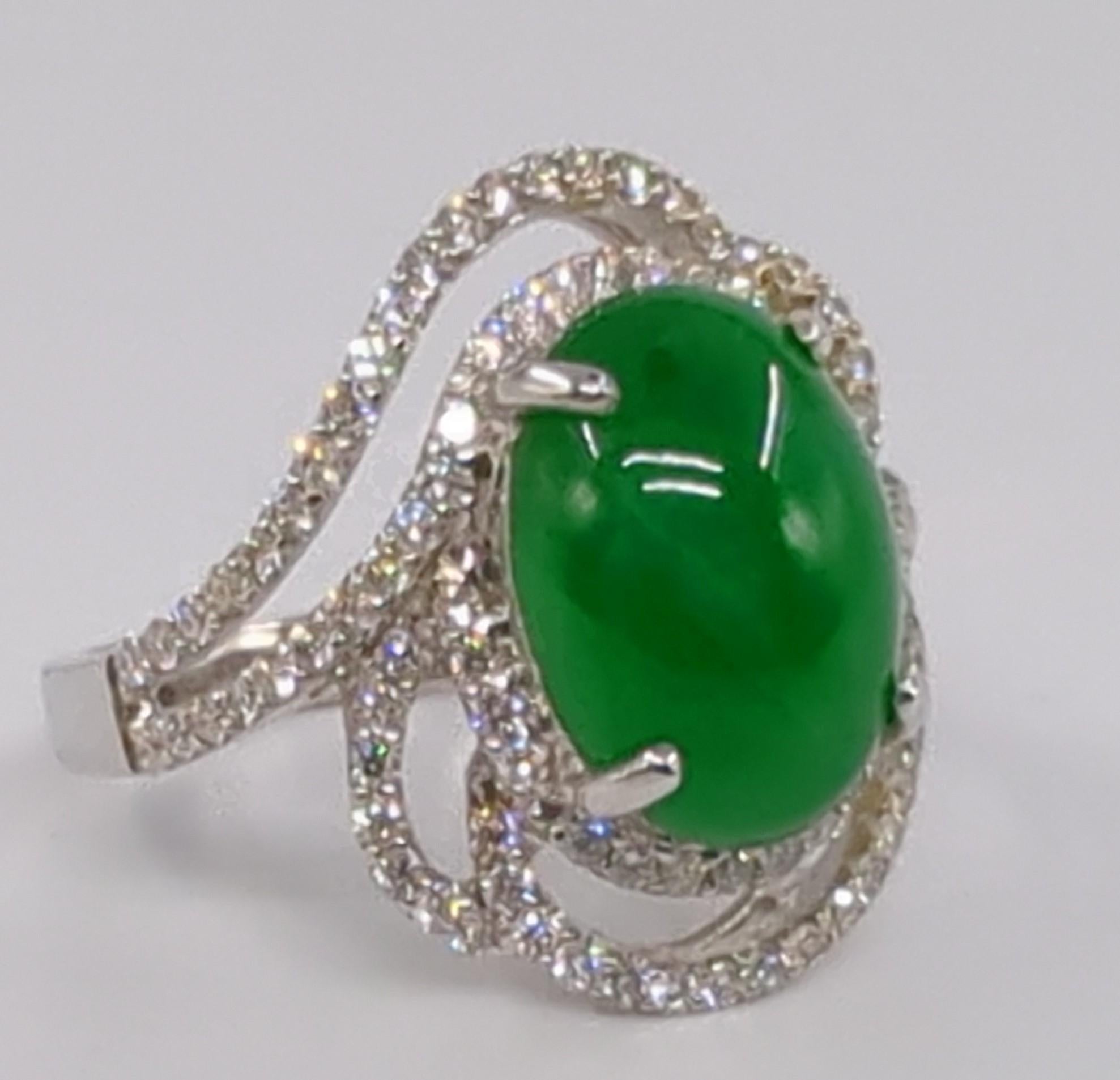 This exquisite ladies' ring is crafted in 18K white gold and weighs 6.50 grams. It features a stunning oval cabochon of intense green jadeite at its center. The jadeite is of A-grade quality, as certified by the NGTC (National Gemstone Testing