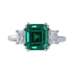 18k Wg Ring with Tr. Diamond 0.73ct and Emerald 2.44ct