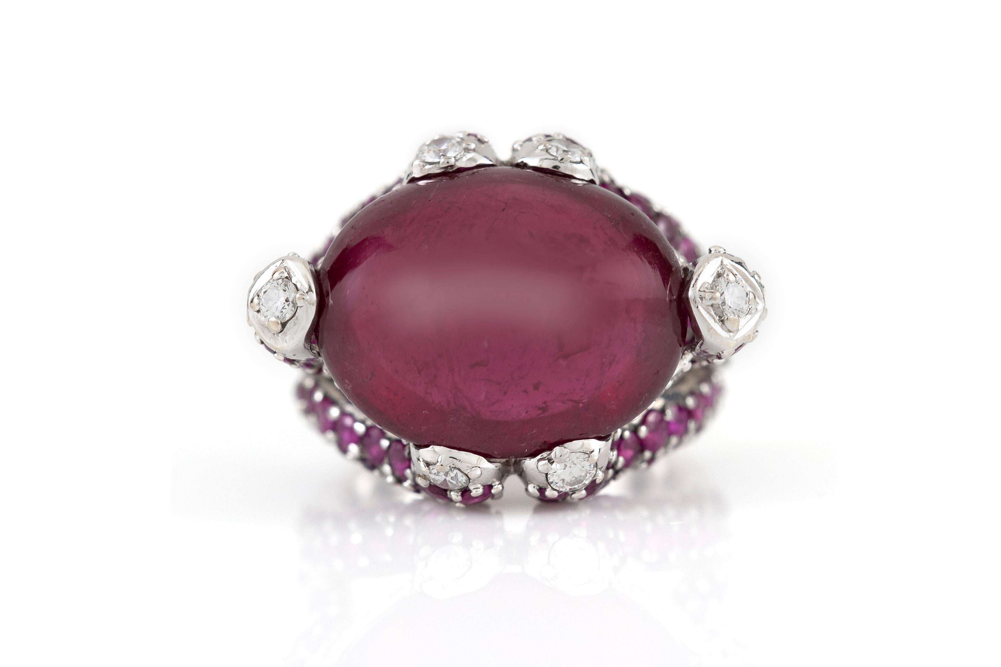 The ring is finely crafted in 18k white gold with robelite as center stone weighing approximately total of 12.00 carat, diamonds on the side weighing approximately total of 0.20 carat and ruby on the side weighing approximately total of 2.00 carat.
