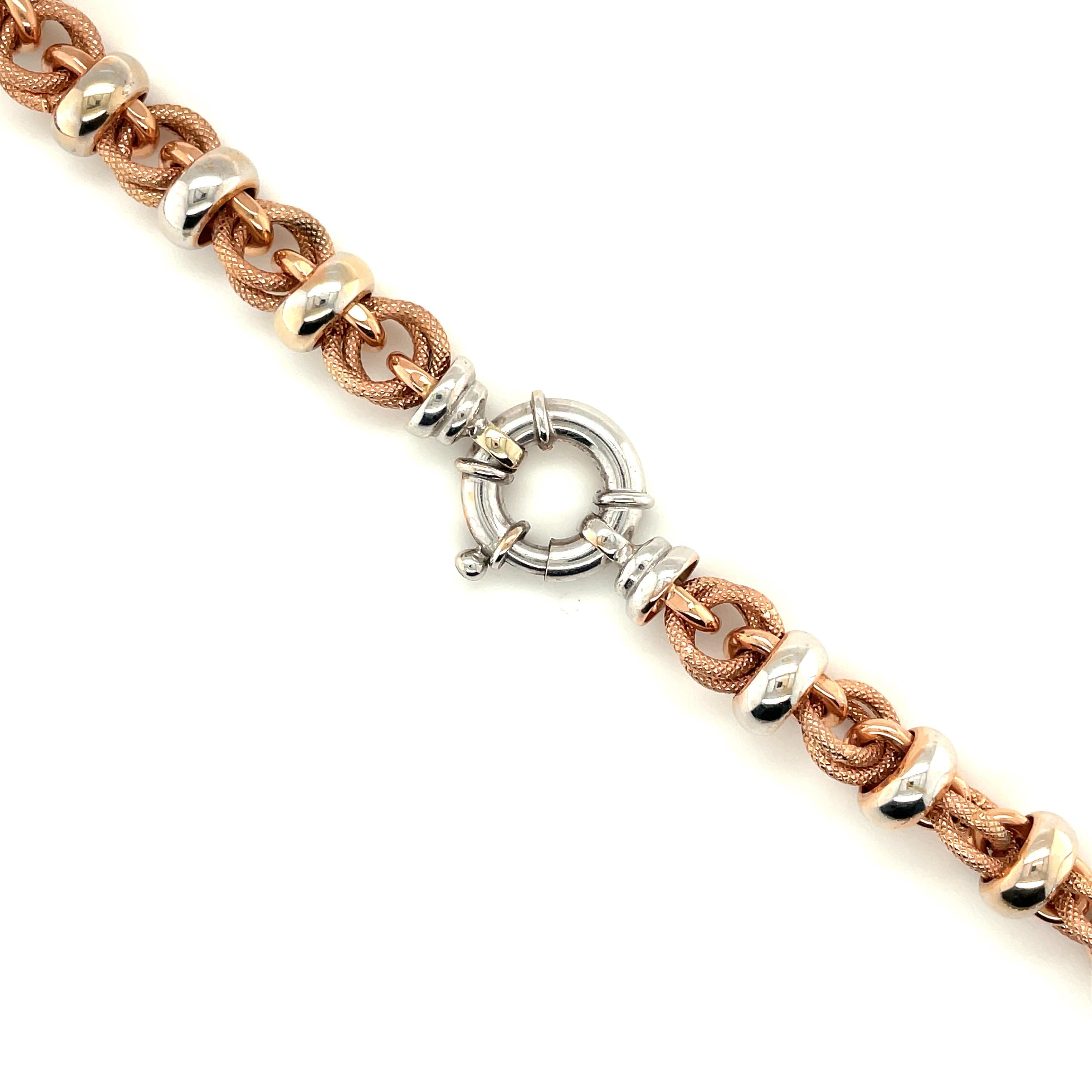 18K White and Rose Gold Link Necklace

Marked 18K Italy and having Italian assay mark 1760 AR. Completed by a spring ring clasp. Rose gold links having a textured surface, juxtaposed with with gold links having a high polish finish.

Grams 50.80

17
