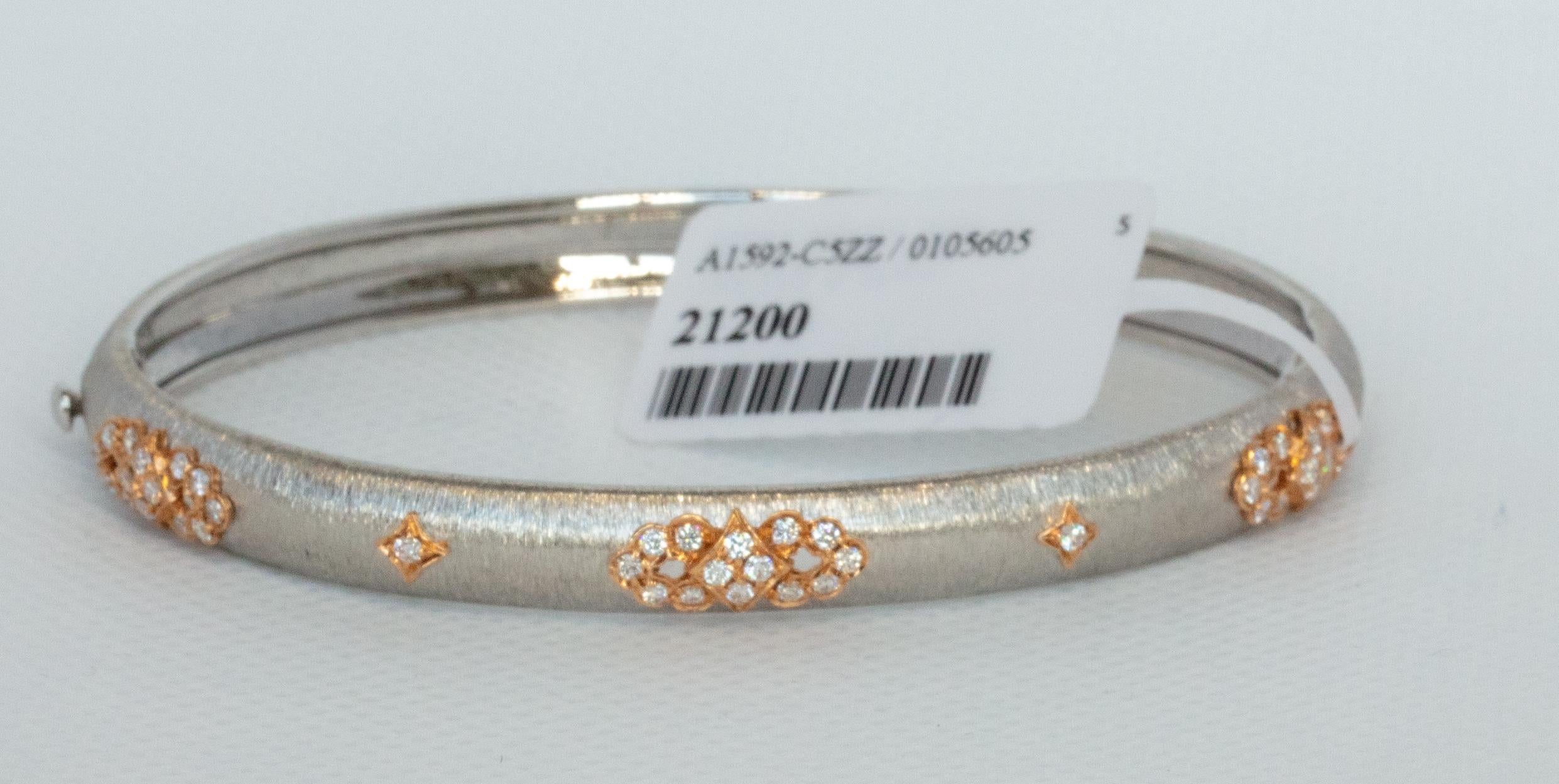 WHITE AND ROSE GOLD BANGLE
44 ROUND DIAMONDS - 0.43cts
18KWR - 9.88 gm
size - 48 x 58 mm (2.28 x 1.89 inch) Other sizes are available upon request, for example, 45x55mm  (1.77x2.17inch)

This unique piece is made using the Florentine exquisite