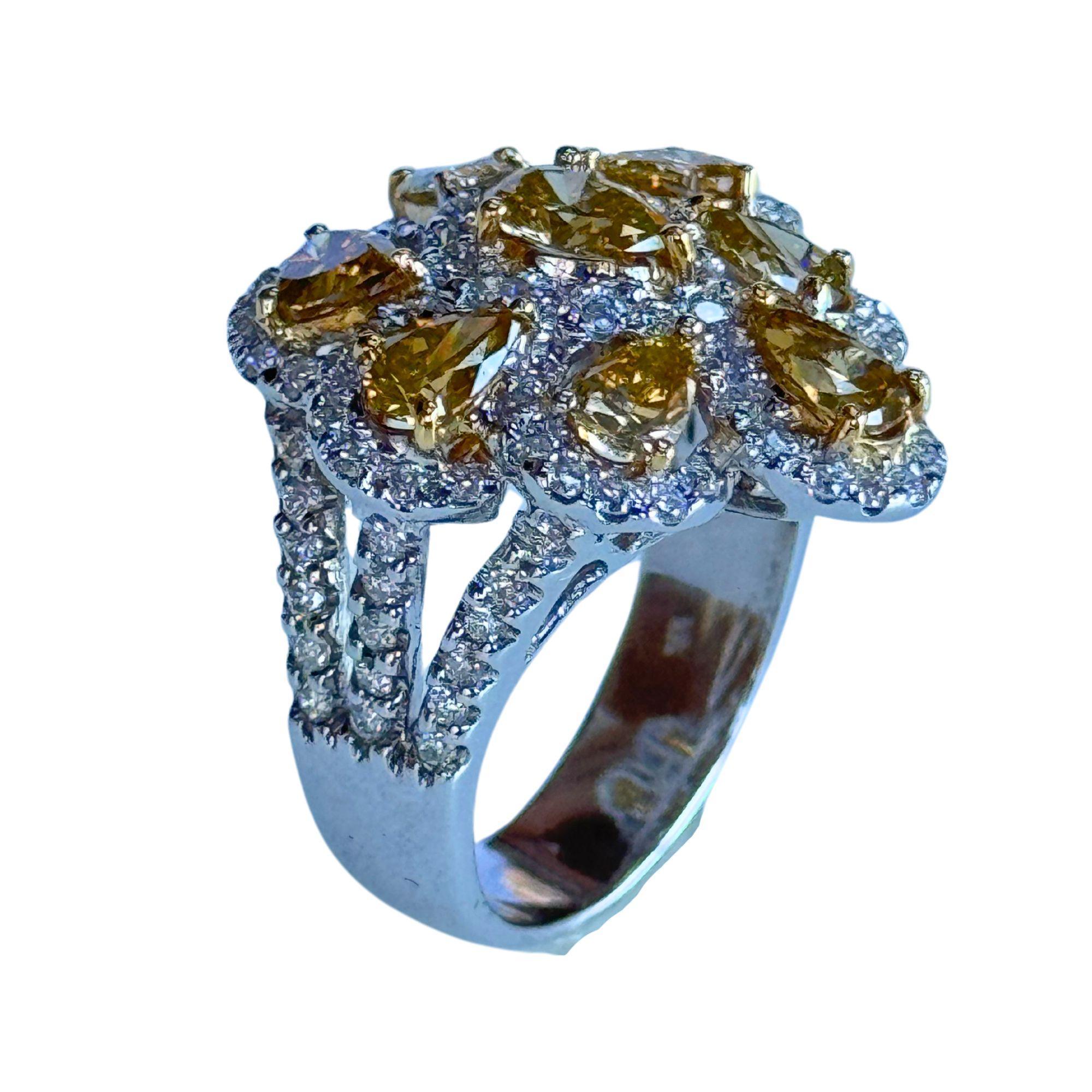 Look at this 18k White and Yellow Diamond Ring. Weighing 10.70 grams and sized at 6.75, this ring packs a punch of modern elegance. The yellow diamonds weigh a total of 2.34 carats paired with white diamonds weighing 1.14 carats. Size up your style