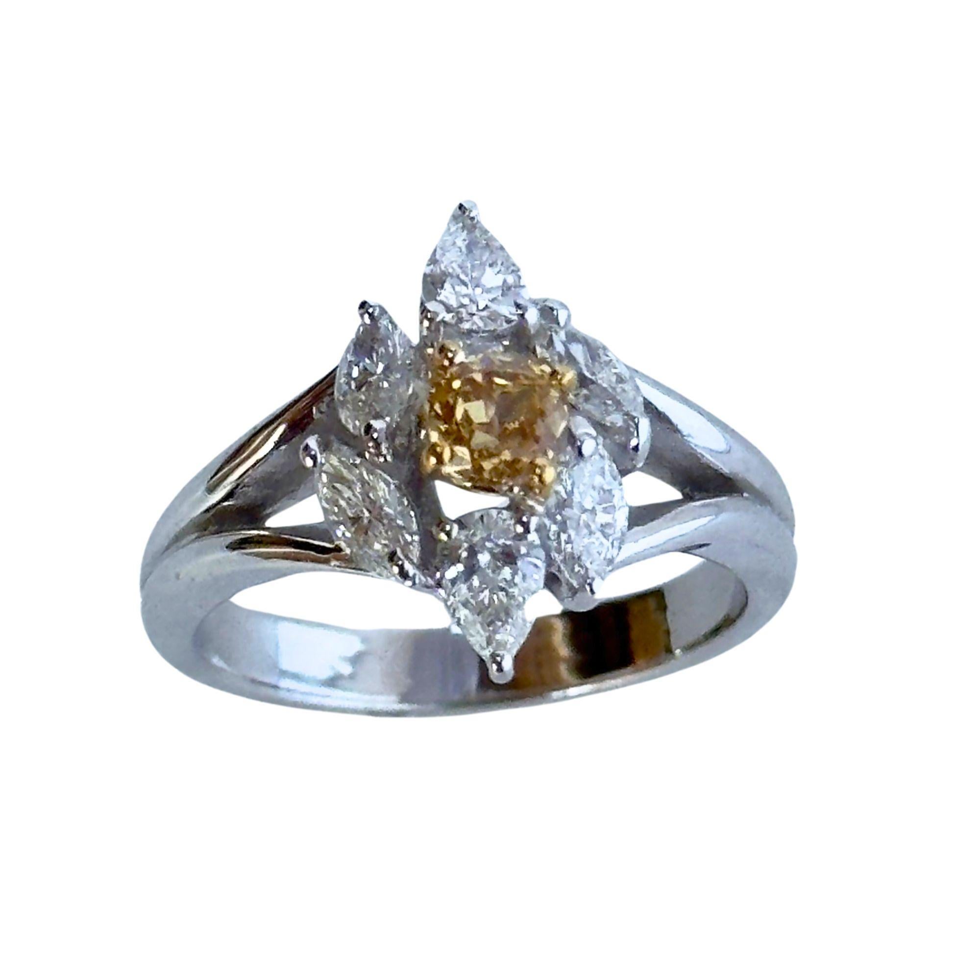 Introducing our exquisite 18k White and Yellow Diamond Ring. Weighing 5.7 grams and featuring a size 6 ring, this captivating piece showcases a brilliant 0.81-carat yellow diamond at its center, complemented by surrounding white diamonds for a total