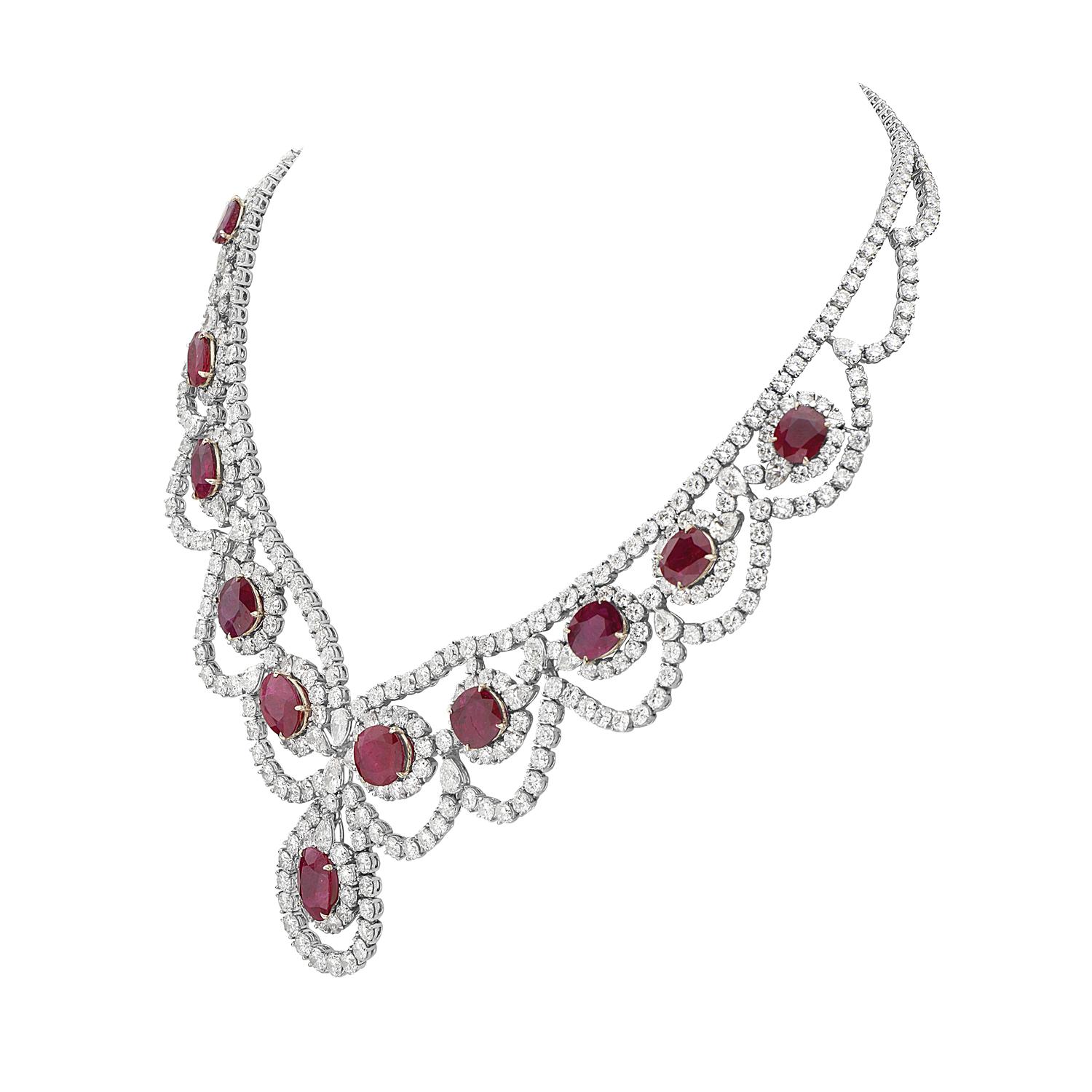 This statement necklace features 46.25 carats of F-H VS-SI pear and round brilliant diamonds, and 42.23 carats of cushion mixed cut red moderately strong rubies set in 18K white and yellow gold. This intricate piece features 23 pear brilliant