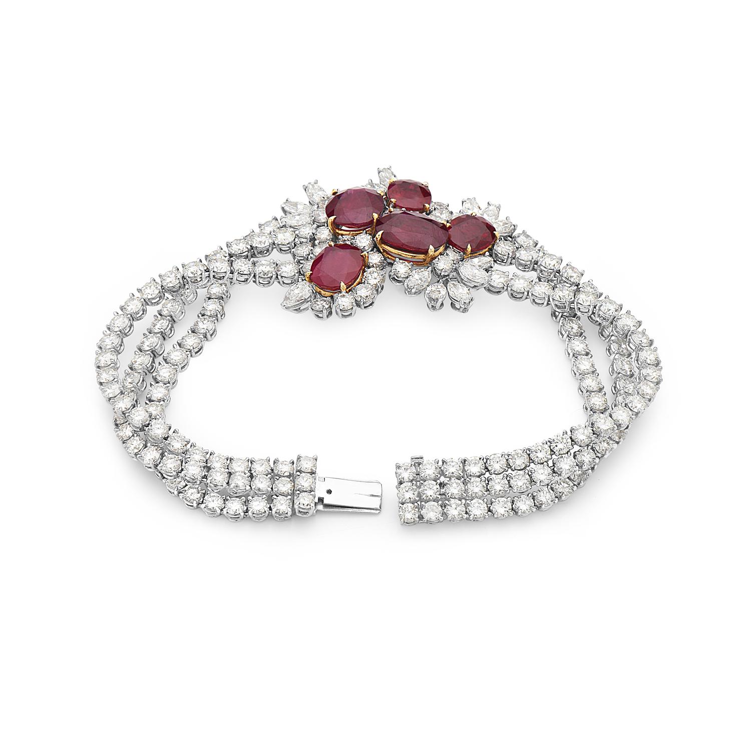 This bracelet features 28.05 carats of F-H VS-SI diamonds and 13.49 carats of moderately strong transparent red rubies. This bracelet features 1 pear brilliant, 13 marquise brilliant, and 163 round brilliant diamonds along with 5 rubies. Made in