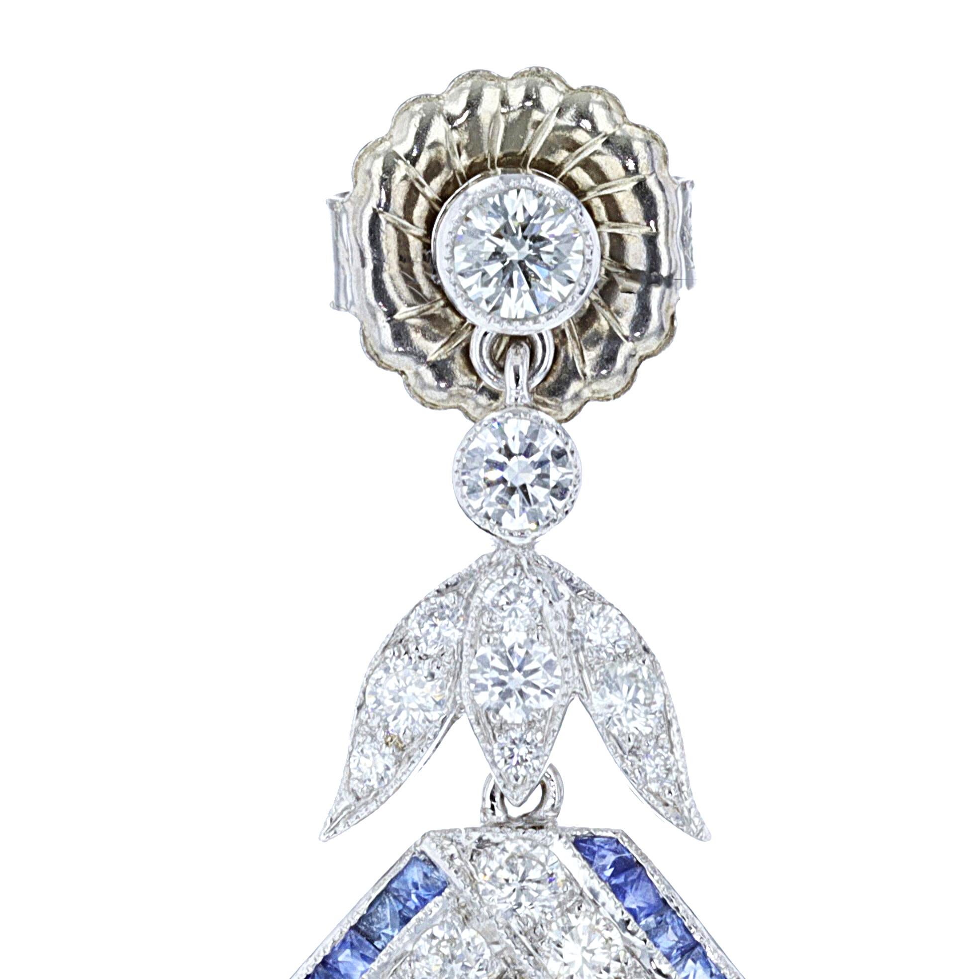 Extraordinary vintage 18K White and Yellow Gold Diamond and Sapphire earrings that absolutely beg to be included in a special night out on the town. The earrings feature sparkling round cut diamonds that weigh approximately 2.00ct. and are