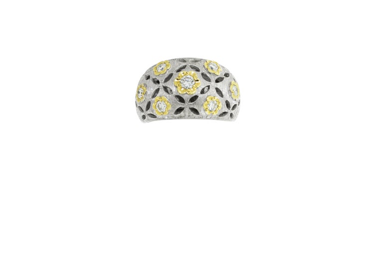 This ring features hammered 13 grams of 18K white gold with eyelet cutouts, and yellow gold flowers surrounding 0.56 carats of round brilliant diamonds. Size 7.5. Made in Italy. 

Can be sized down upon request. 

Viewings available in our NYC
