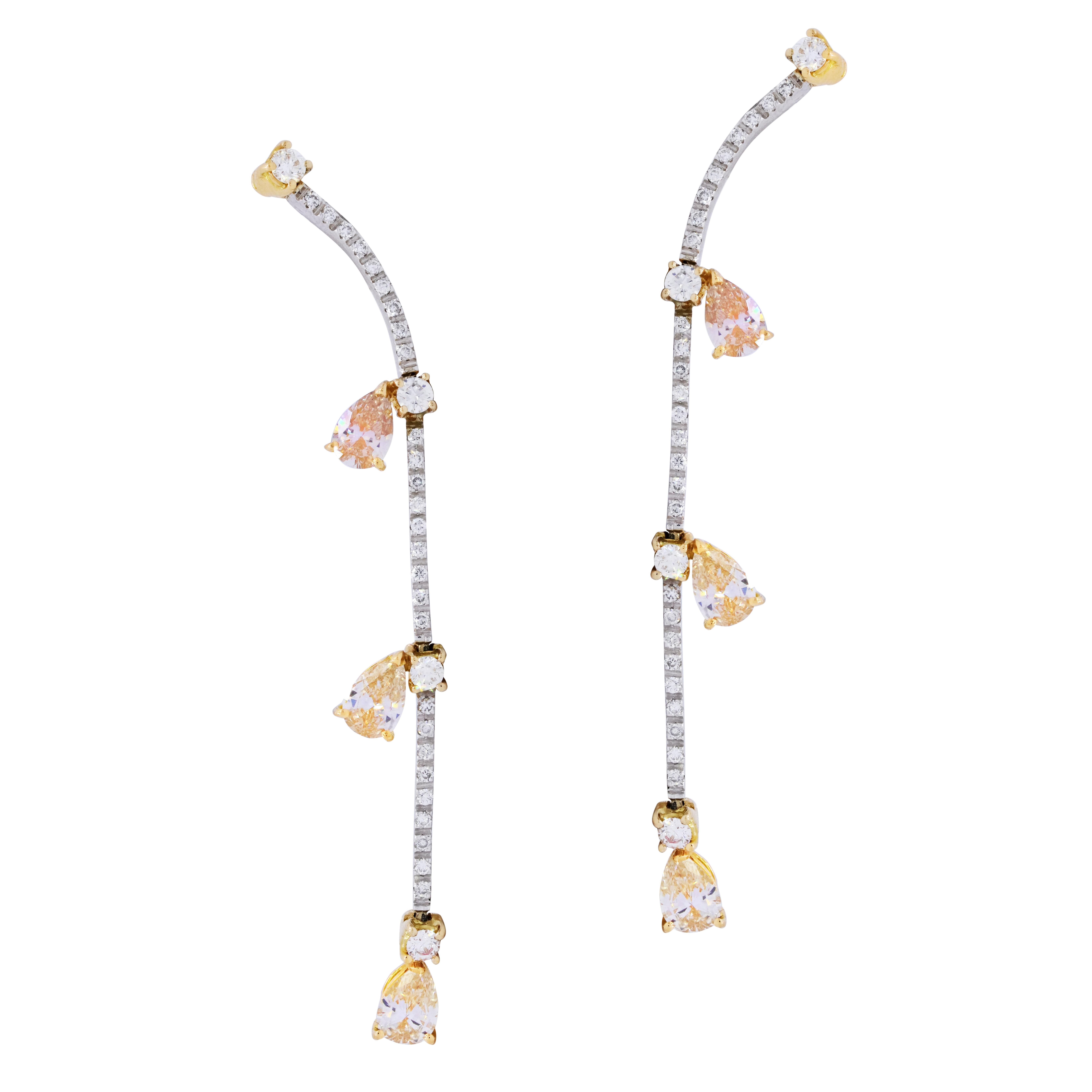 18k white and yellow gold hanging diamonds earrings, features 3.00 carats of  pear shape brown diamonds and white round diamonds.
