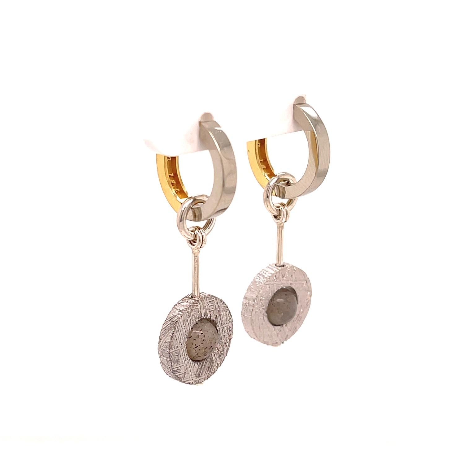 A pair of 18k yellow and white gold reversible huggie earrings, with a pair of donut shaped meteorite Jackets, made in oxidized sterling silver. These earrings were made and designed by llyn strong.

Items sold separately upon request.