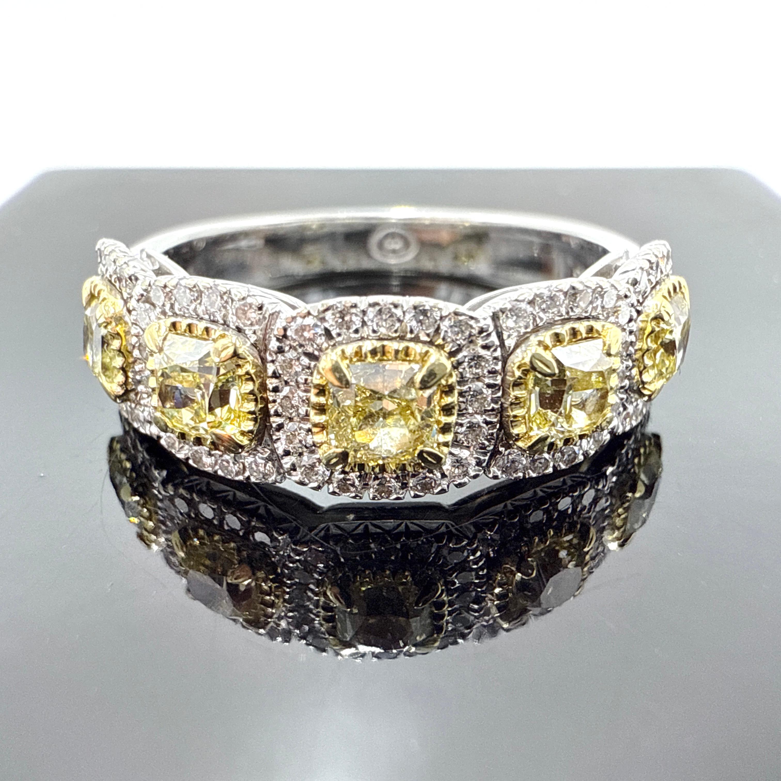 This beautiful ring is crafted in 18K white gold and features a band of alternating white and yellow gold elements. The piece is hand-assembled and finished, measuring 7.20 mm at the top and tapering to 3.50 mm at the base of the shank. The