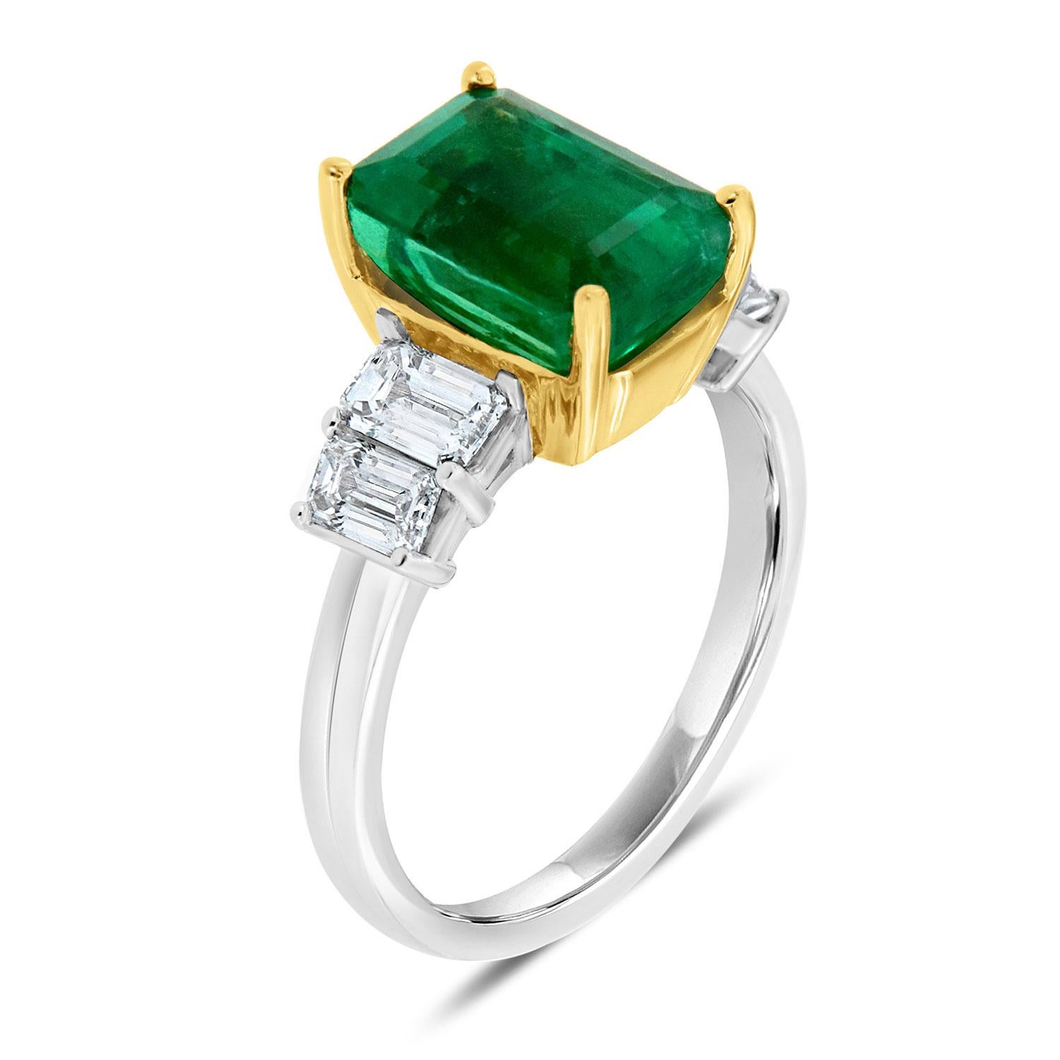 This 18k Two-Tone Gold hand-crafted ring features a vibrant Green Ethiopian Emerald - Shaped Natural Emerald. This unique emerald exhibits a similar color to a Colombian Emerald. Very light included, nothing is visible to the naked eye. The emerald