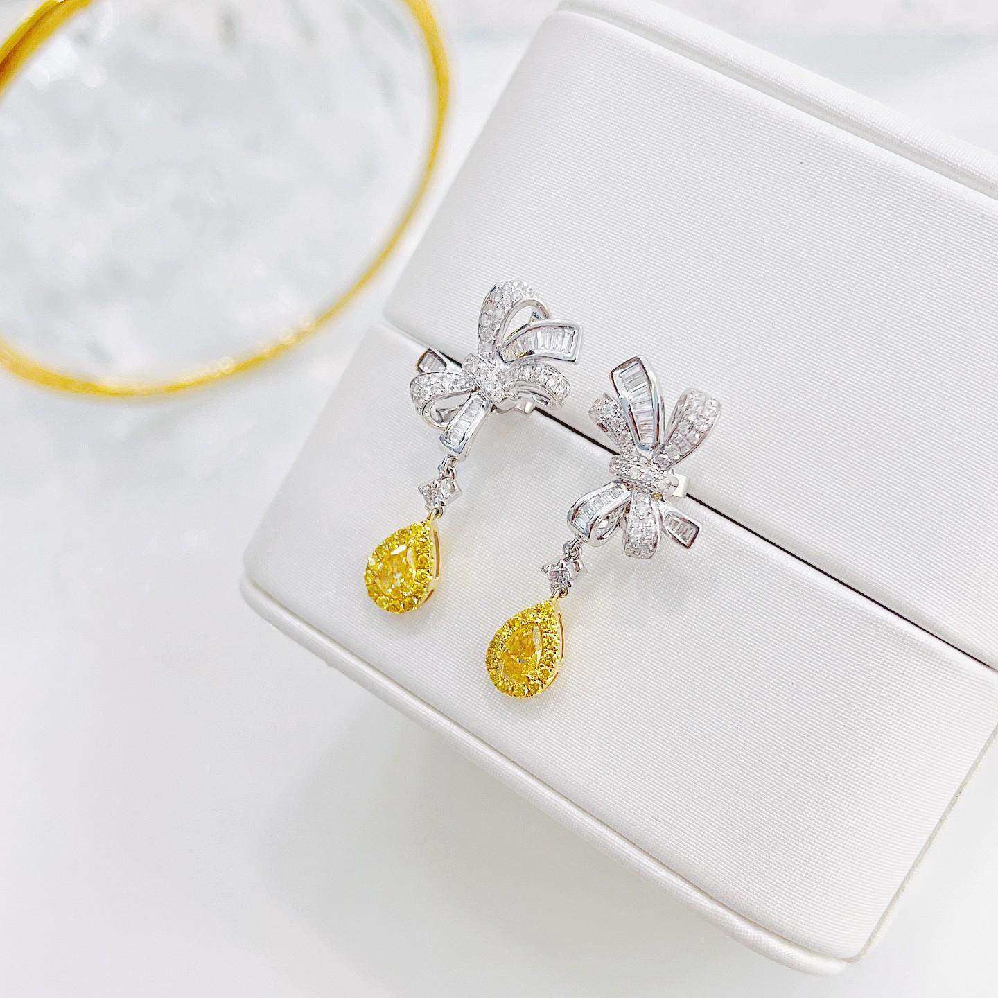 Modern 18K White and Yellow Gold Teardrop Bow Earrings with Yellow and White Diamonds For Sale