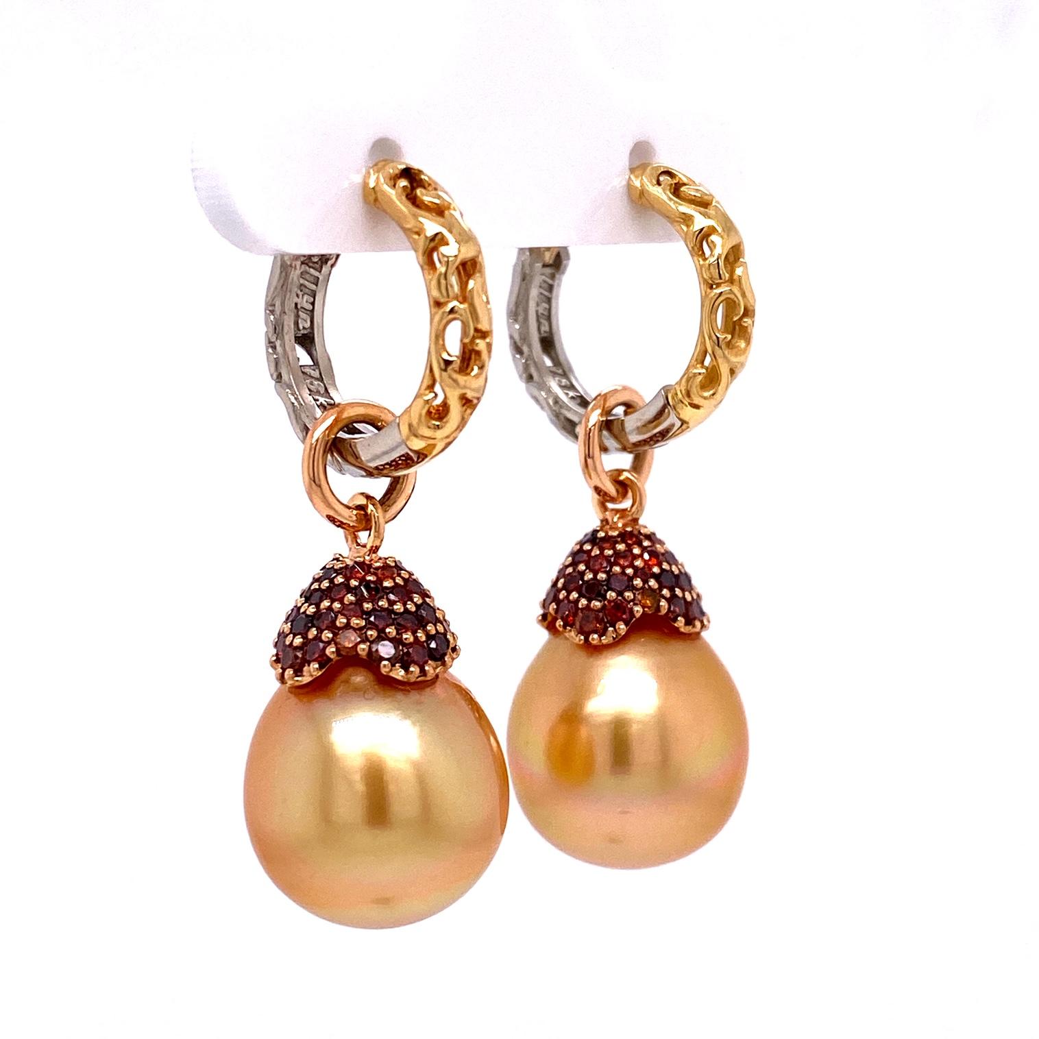 A pair of reversible 18k yellow and white gold scroll style huggie hoops, with a pair of 12x15.5mm golden south sea pearls with 18k rose gold caps set with 104 cabernet colored diamonds, .86tcw. These earrings were made and designed by llyn