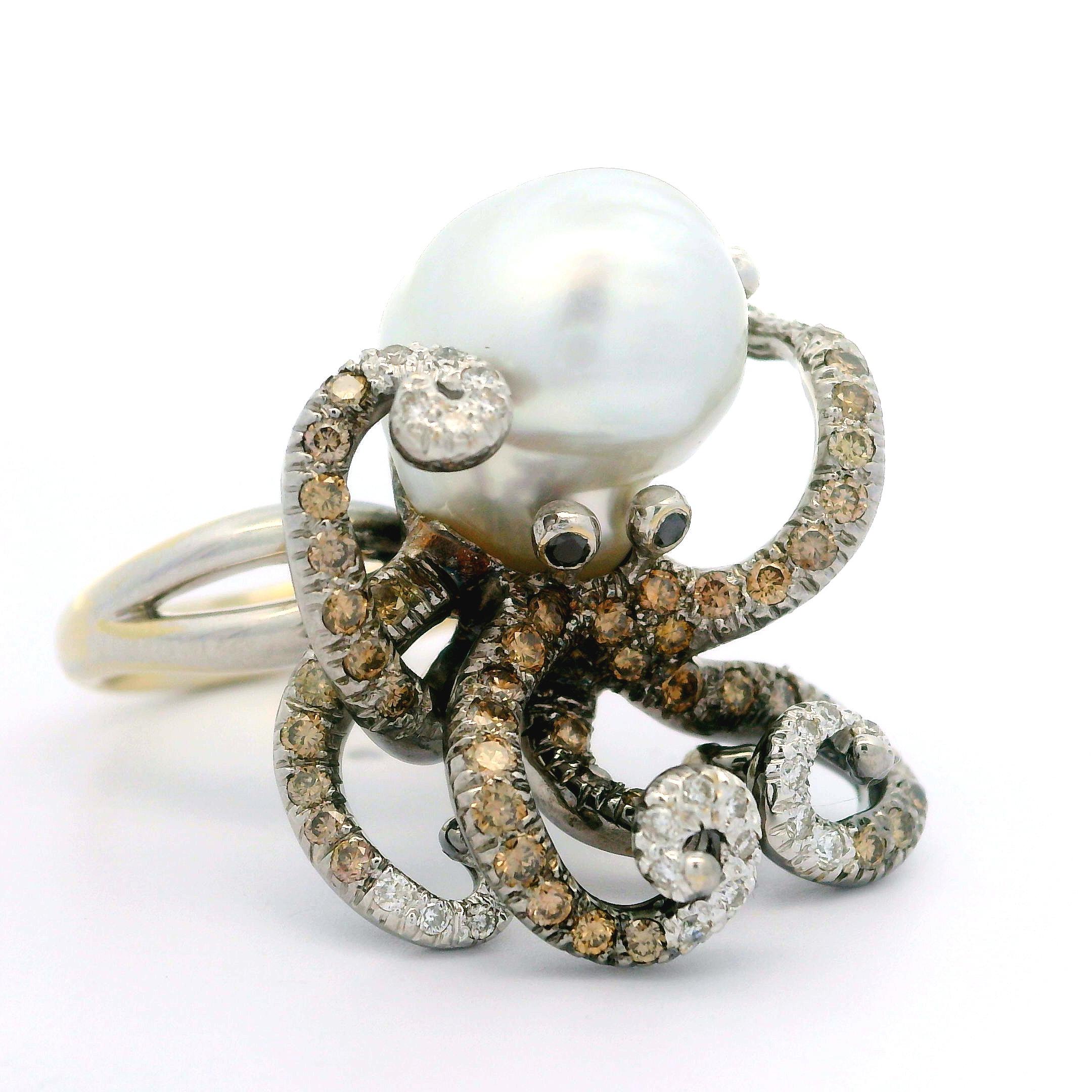 --Stone(s):--
(1) Genuine Cultured Pearl - Baroque Shape - Stem Set - White Color - 14.4x11.7mm (approx.)
Numerous Natural Genuine Diamonds - Round Brilliant Cut - Pave Set - VS2-I1 Clarity - Fiery White & Fancy Champagne Color - 0.80-1.0ctw