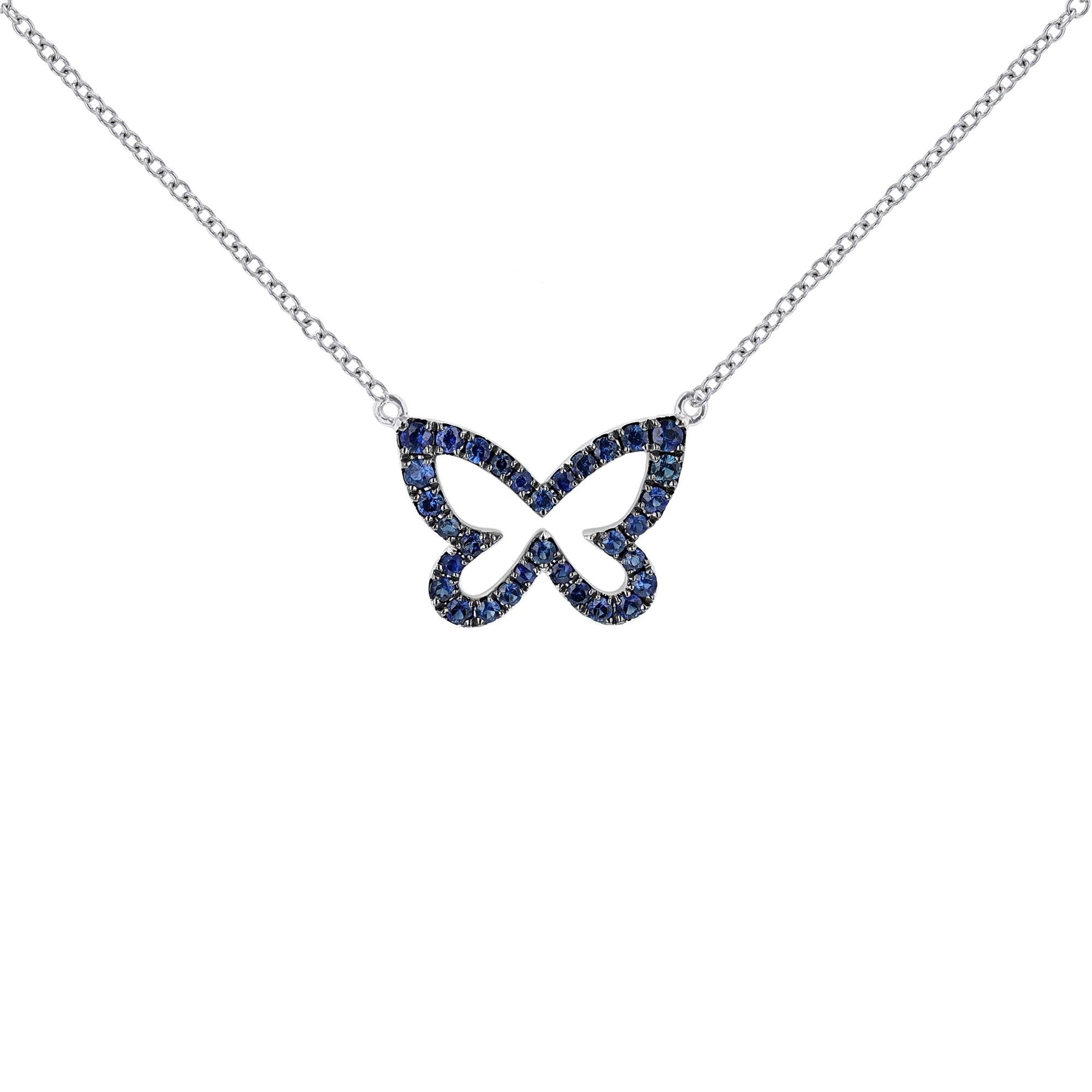 This necklace is made in 18K white gold and features a butterfly pendant of 32 round cut, prong set blue sapphires. With 2 diamond and 2 blue sapphire bezel stations on the chain.  Necklace has a color grade (H). and clarity grade (SI2).  Blue
