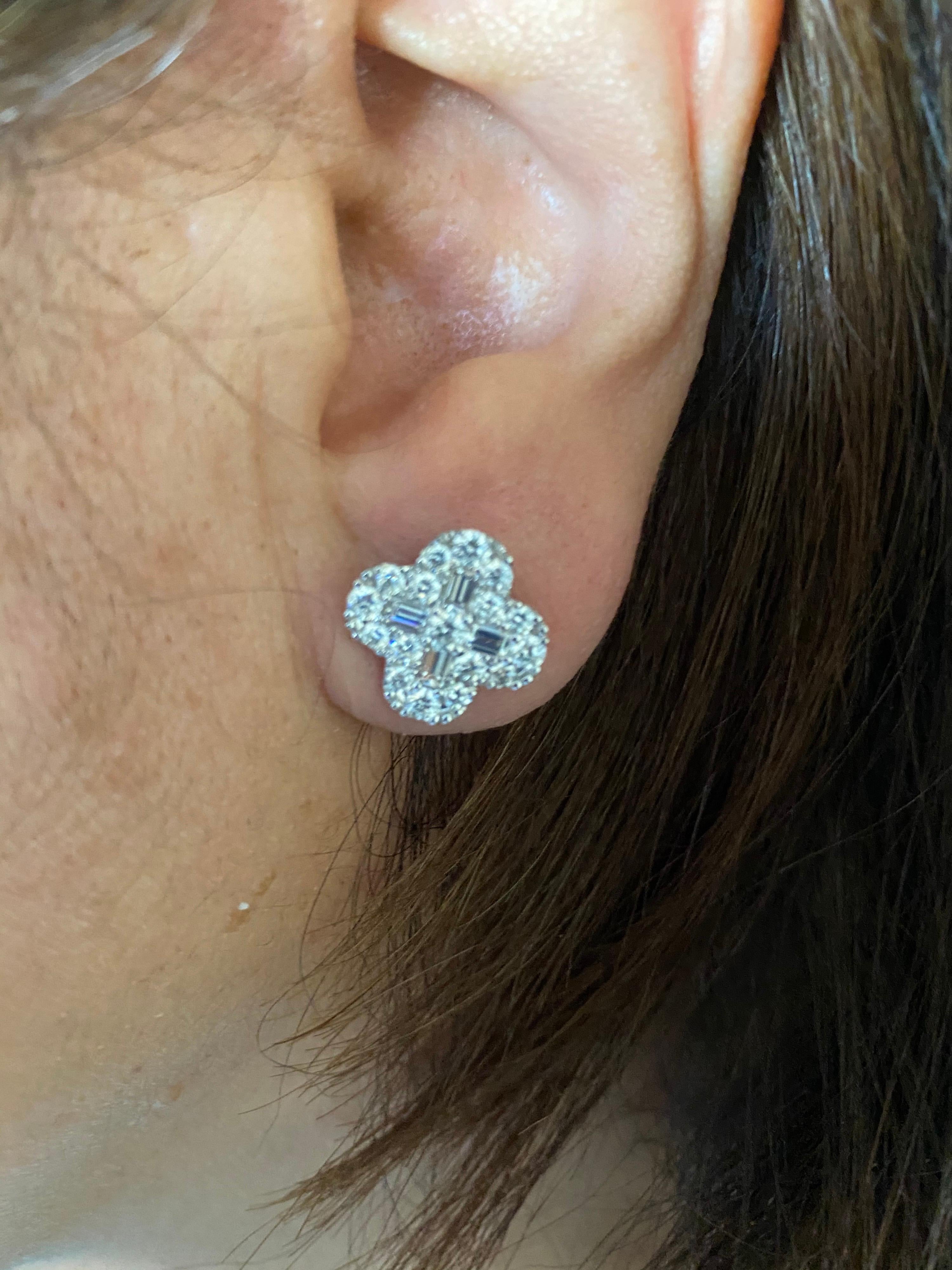 18K white gold diamond earring set in a clover Van Cleef shape. The earrings are set with baguette and round diamonds. The total carat weight is 2.12. The color of the stones are F, the clarity is VS1-VS2.