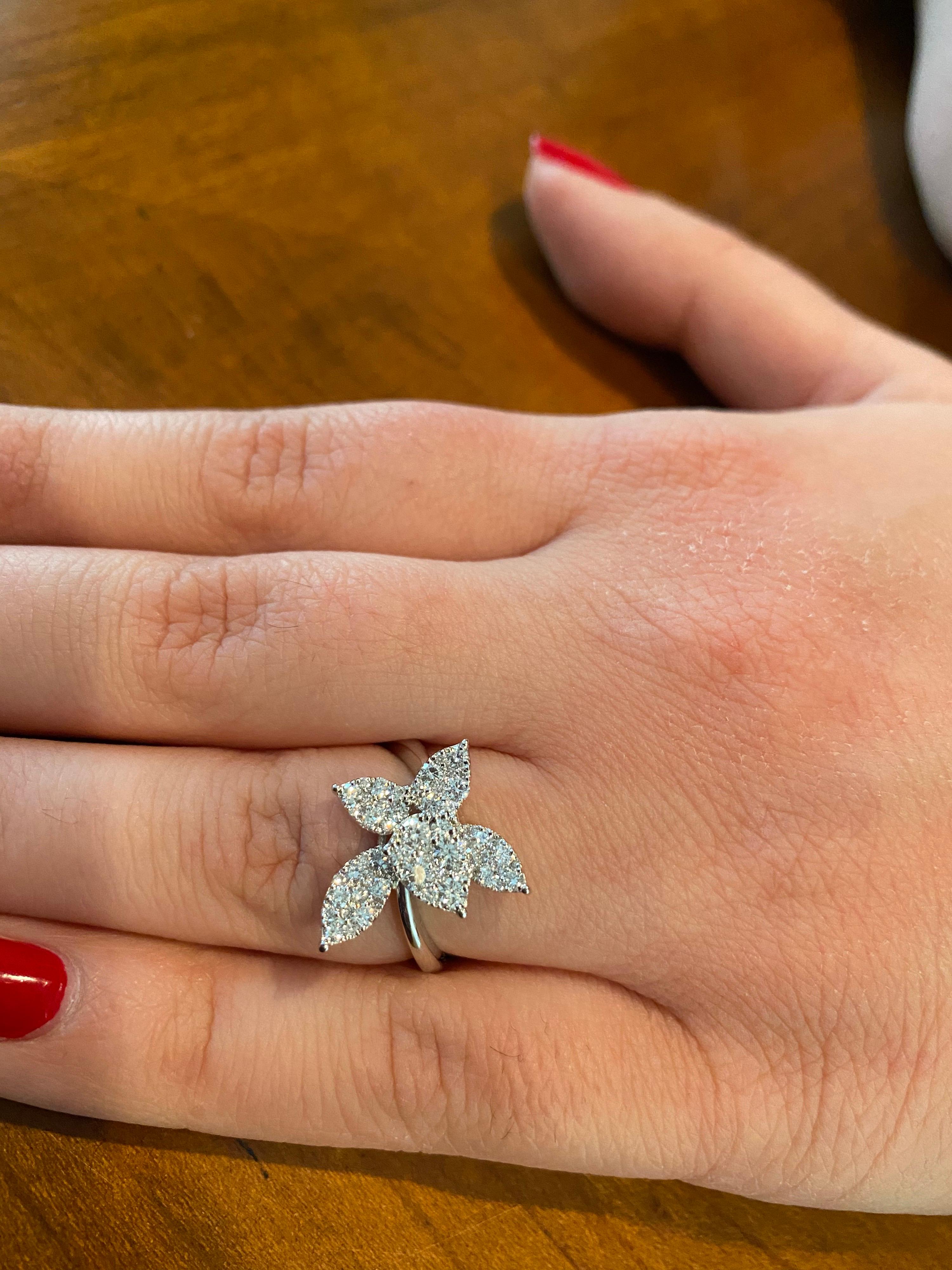 Flower shaped diamond cocktail ring set in 18K white gold. The ring is set with round diamonds and the total weight is 1.07 carats. The color of the stones are F, the clarity is VS1. The ring is a size 6.5.