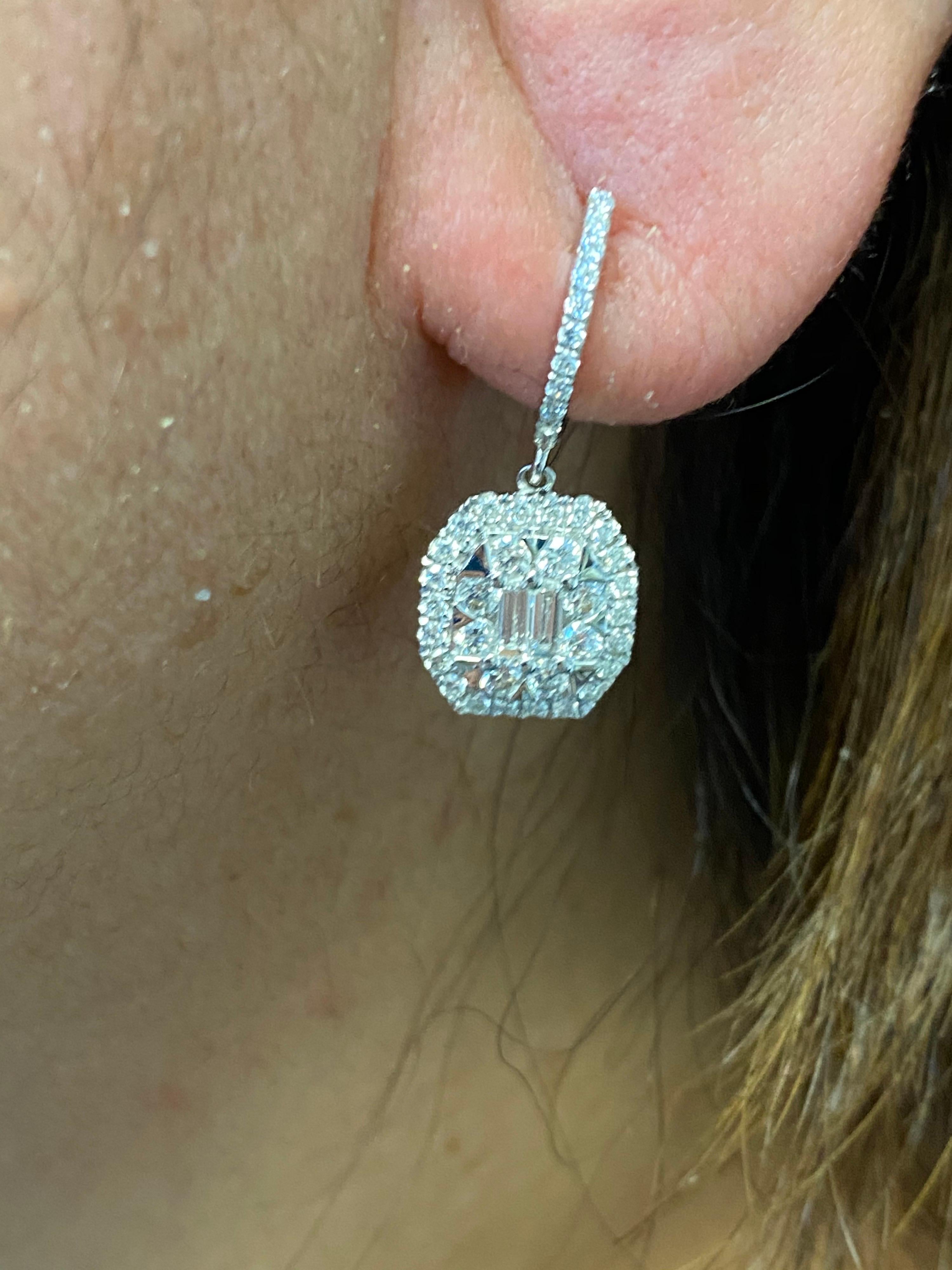 Drop diamond emerald cut illusion setting earrings set in 18K white gold. The pair is set with baguette and round diamonds. The total carat weight is 1.54 carats. The color of the stones are F, the clarity is VS1.