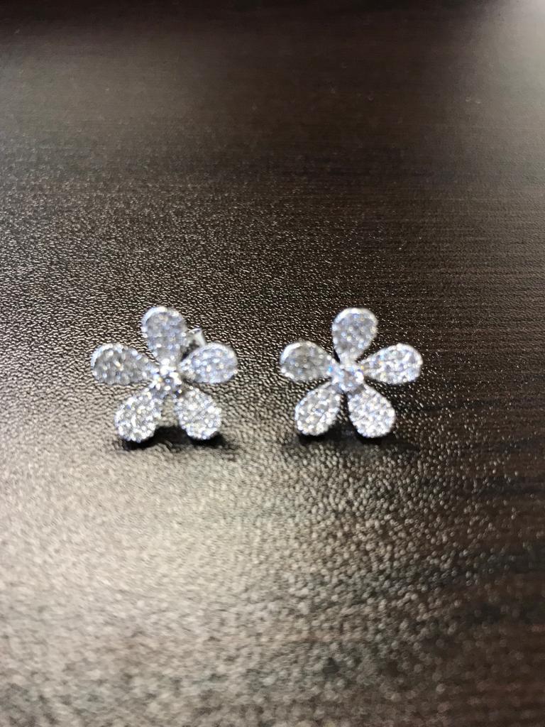 Flower Shaped diamond earrings set in 18K white gold. The earrings are set in a Pave with round diamonds. The total weight is 1.07 carats. The color of the stones are G, the clarity is VS1-VS2. 