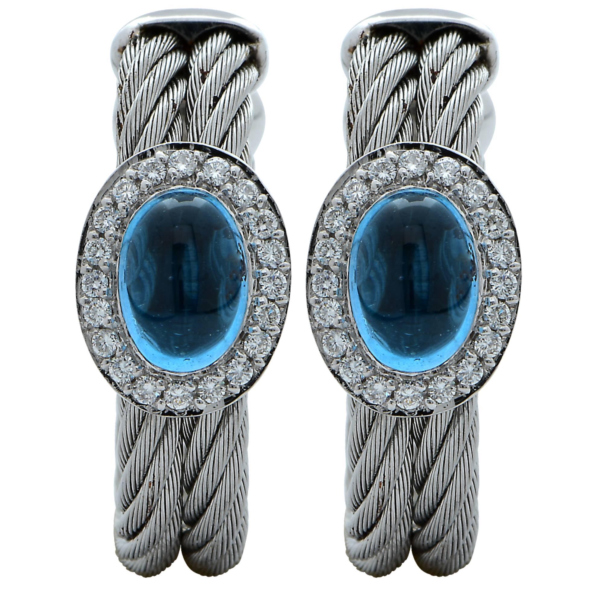 18K white gold and stainless-steel earrings, bangle, and ring set featuring electric vibrant blue cabochon topaz’s surrounded by 84 round brilliant cut diamonds weighing approximately .50ct G VS-SI set on top of a stainless steel twisted wire. The
