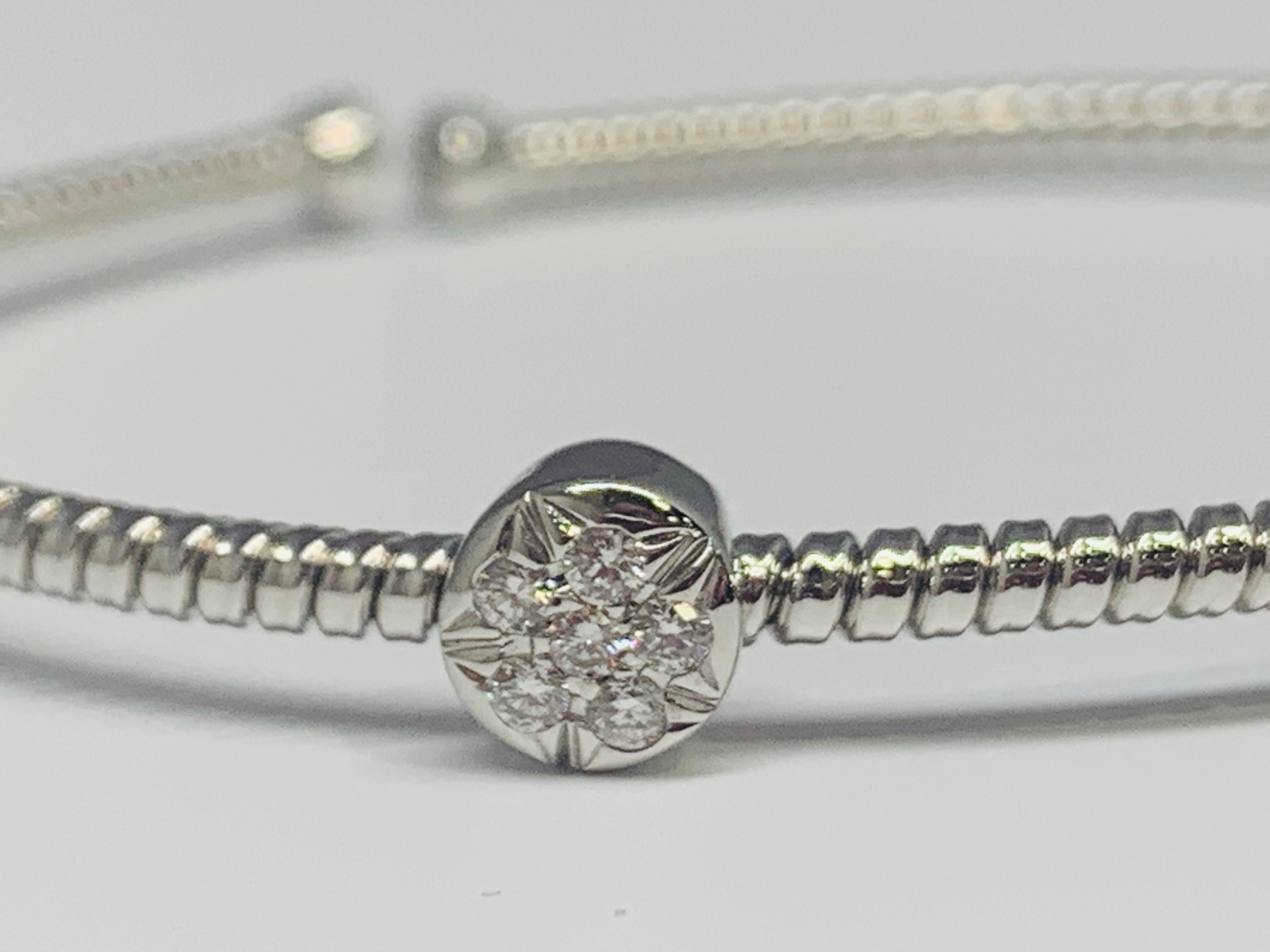 This gorgeous bracelet features 3 beautiful stations and flexes open for a comfortable, easy, and secure wear. Each station holds 6 round diamonds in a cluster-like setting. The total diamond weight of this bracelet is 0.30 carats. The rope-like