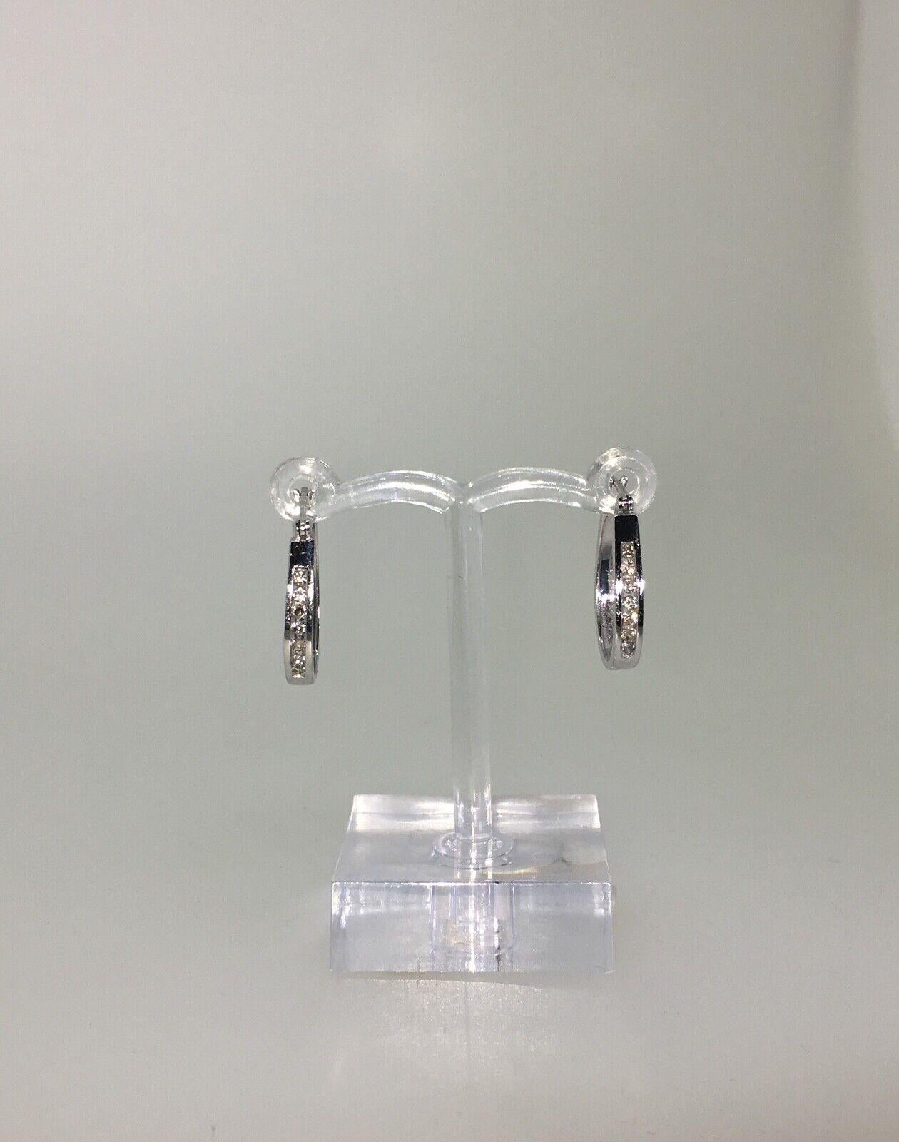 18K White Gold & Diamond Half Hoop Earrings

Each set with 7 round brilliant cut diamonds of good colour and clarity
Total diamonds' weight: 0.30ct approx. 
Length: 20mm 
Total item's weight: 2.8gr. 
