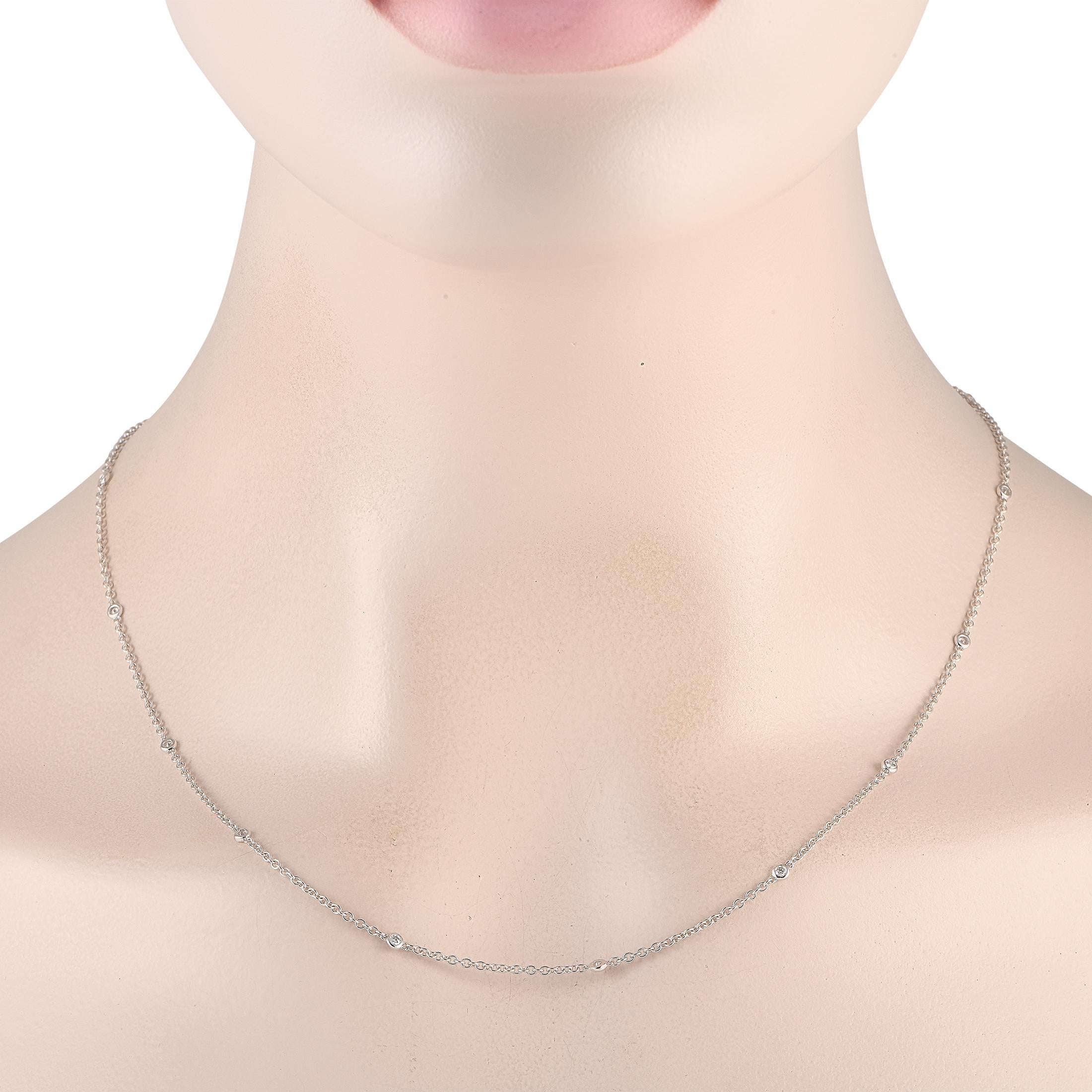 Bezel set diamonds with a total weight of 0.39 carats accent the entirety of this 18K White Gold necklaces delicate 20 chain - the result is a luxurious piece that is sleek, sophisticated, and incredibly refined.This jewelry piece is offered in