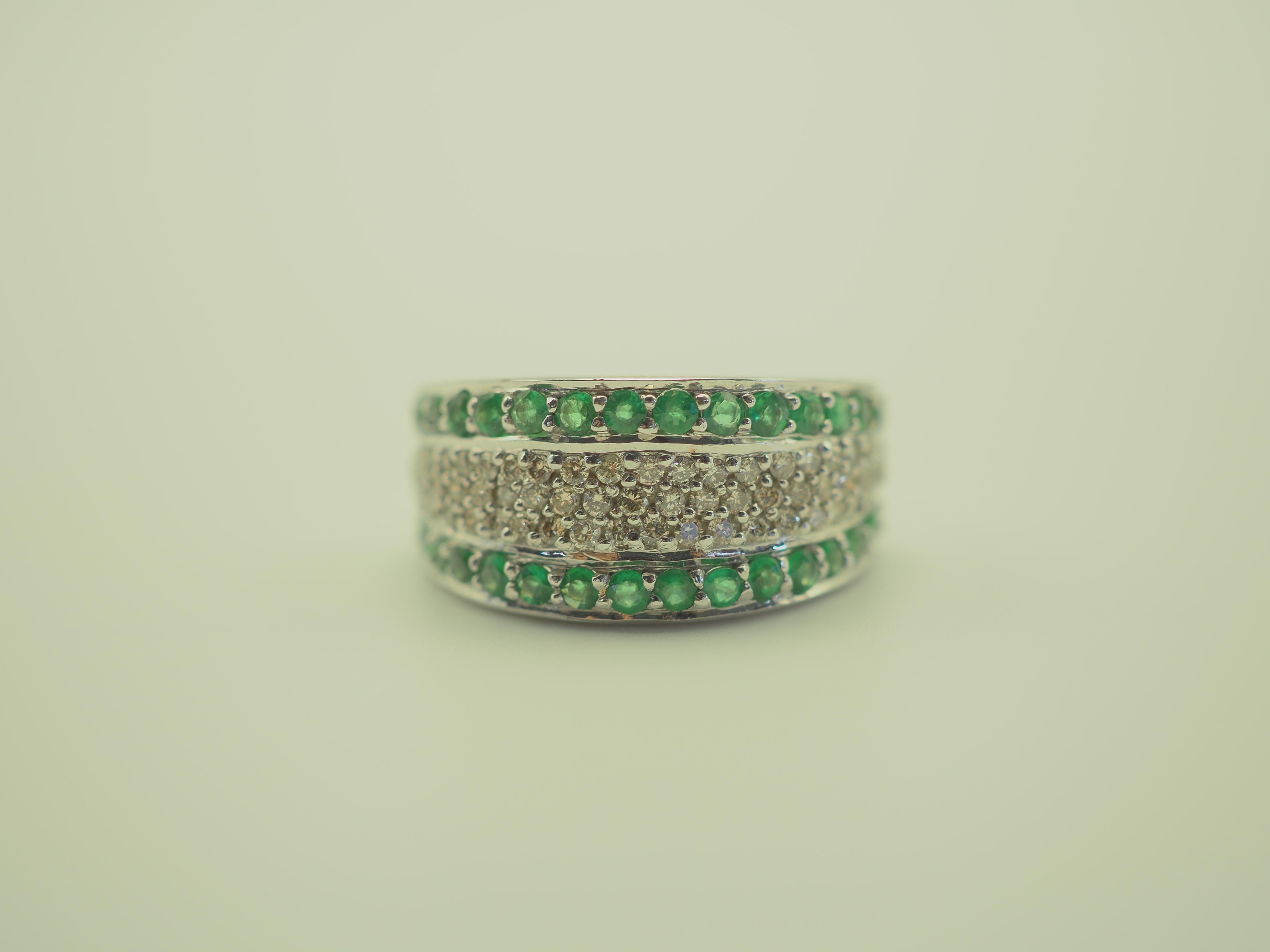 A gorgeous luxury Neo-vintage chunky and fancy band ring. This ring is immaculately designed. The round cut emeralds have a beautiful bright green hue, and the round diamonds are very bright and clean. Wide band and very comfortable, this ring is