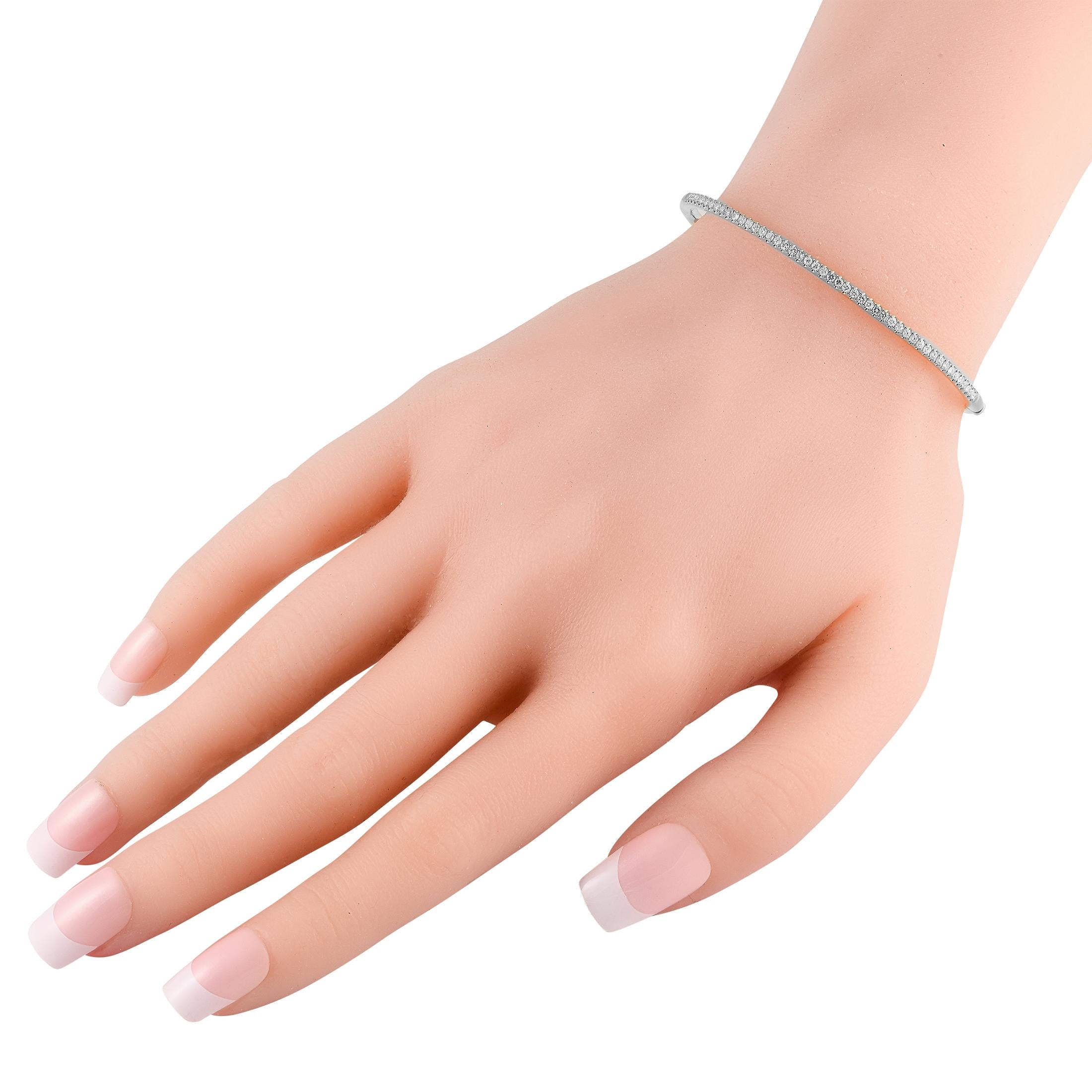 Esta sencilla y sofisticada pulsera brazalete de oro blanco de 18 quilates es decididamente delicada. Una pieza discreta que elevará cualquier ocasión, mide 7,0 de largo y cobra vida gracias a una serie de brillantes diamantes que suman 0,50