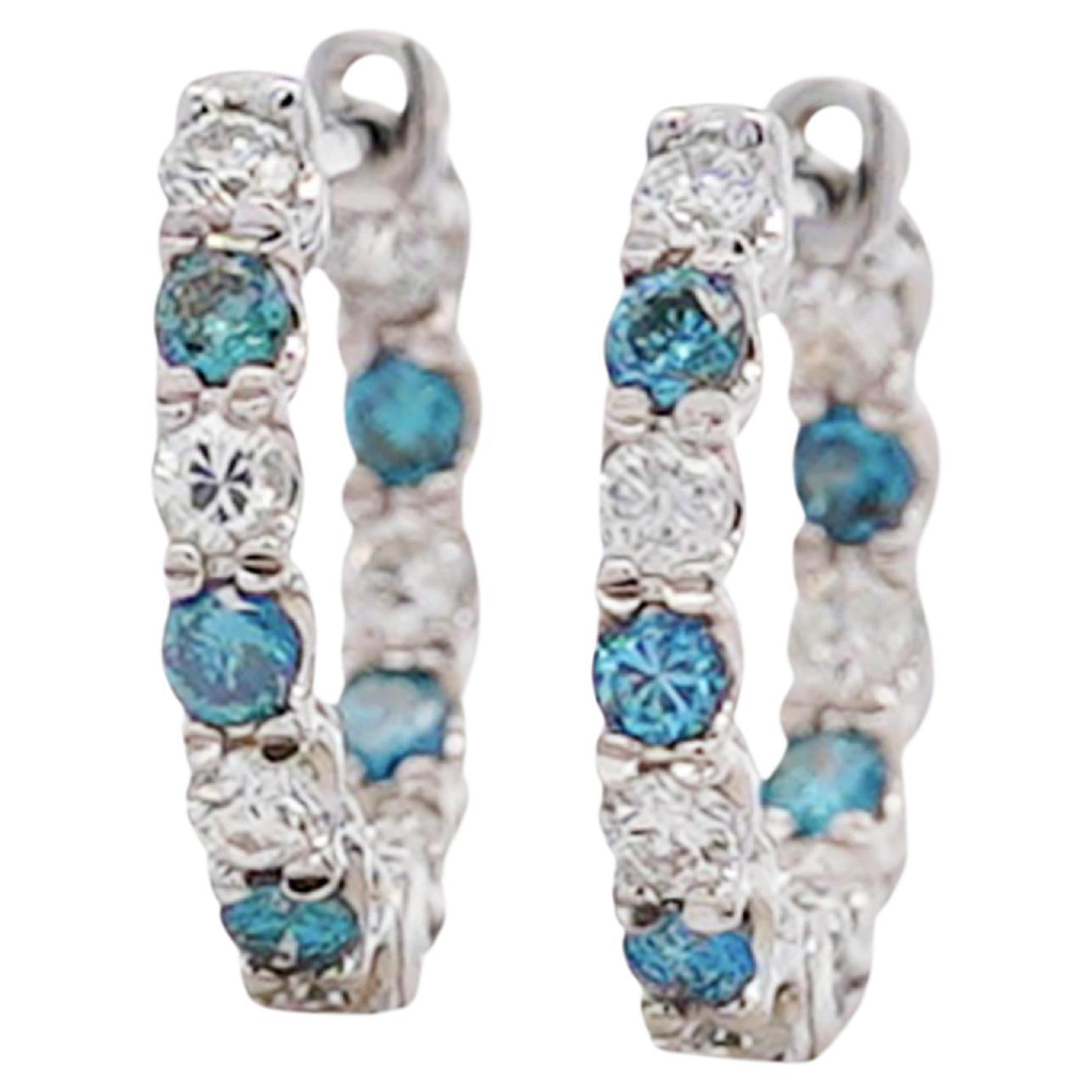 These 18K white gold huggie hoop earrings look fabulous and wear even better. With a latch back closure, these earrings stay safely secured all day. Weighing 1.56 grams, they feel light and comfortable enough for daily wear. The earrings feature a