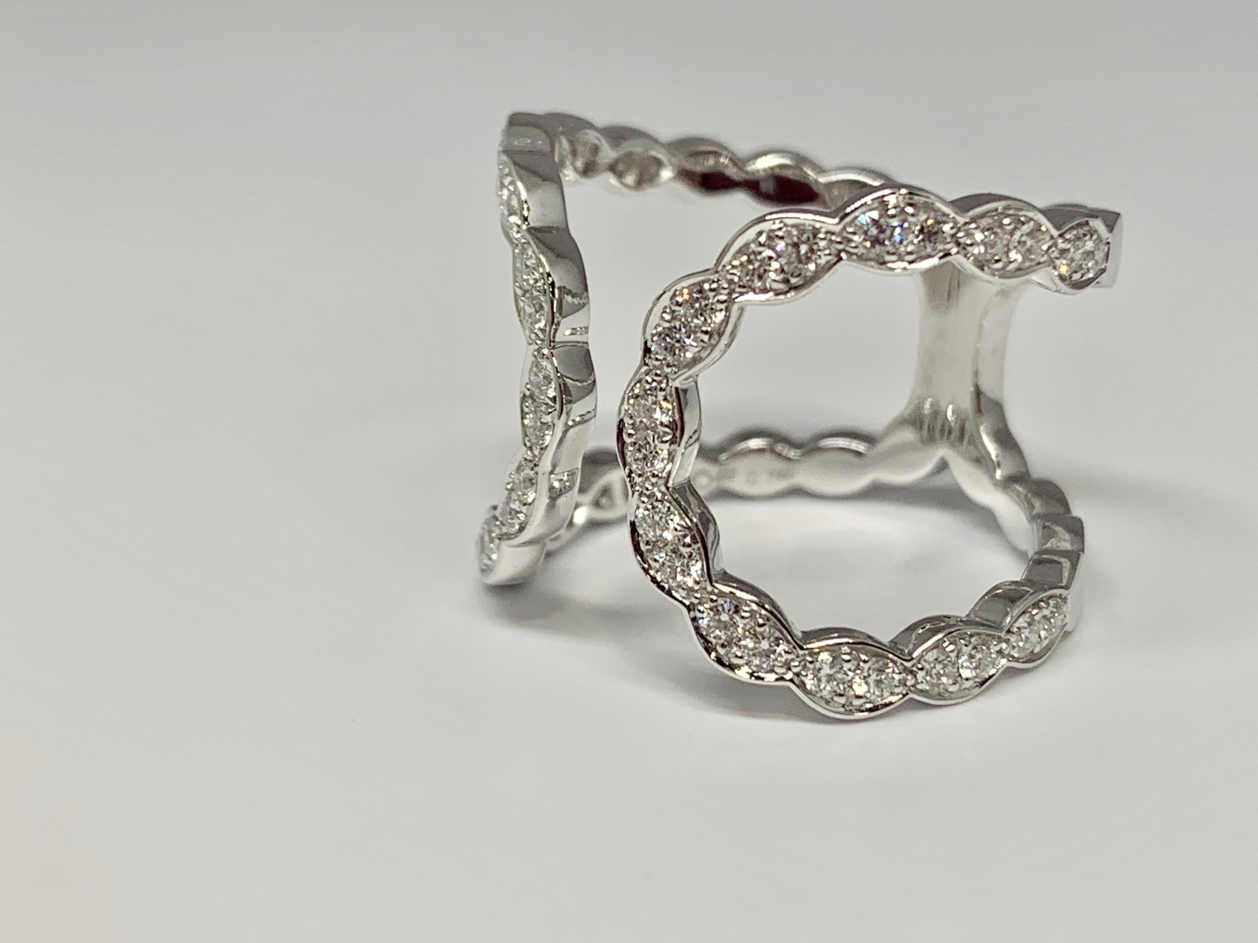 Hearts On Fire Lorelei Diamond Ring featuring a scalloped design and a 0.58 carat weight of round diamonds. This negative space diamond ring is made of 18K white gold. Currently a size 6.5 but can be resized upon request. This piece will be shipped