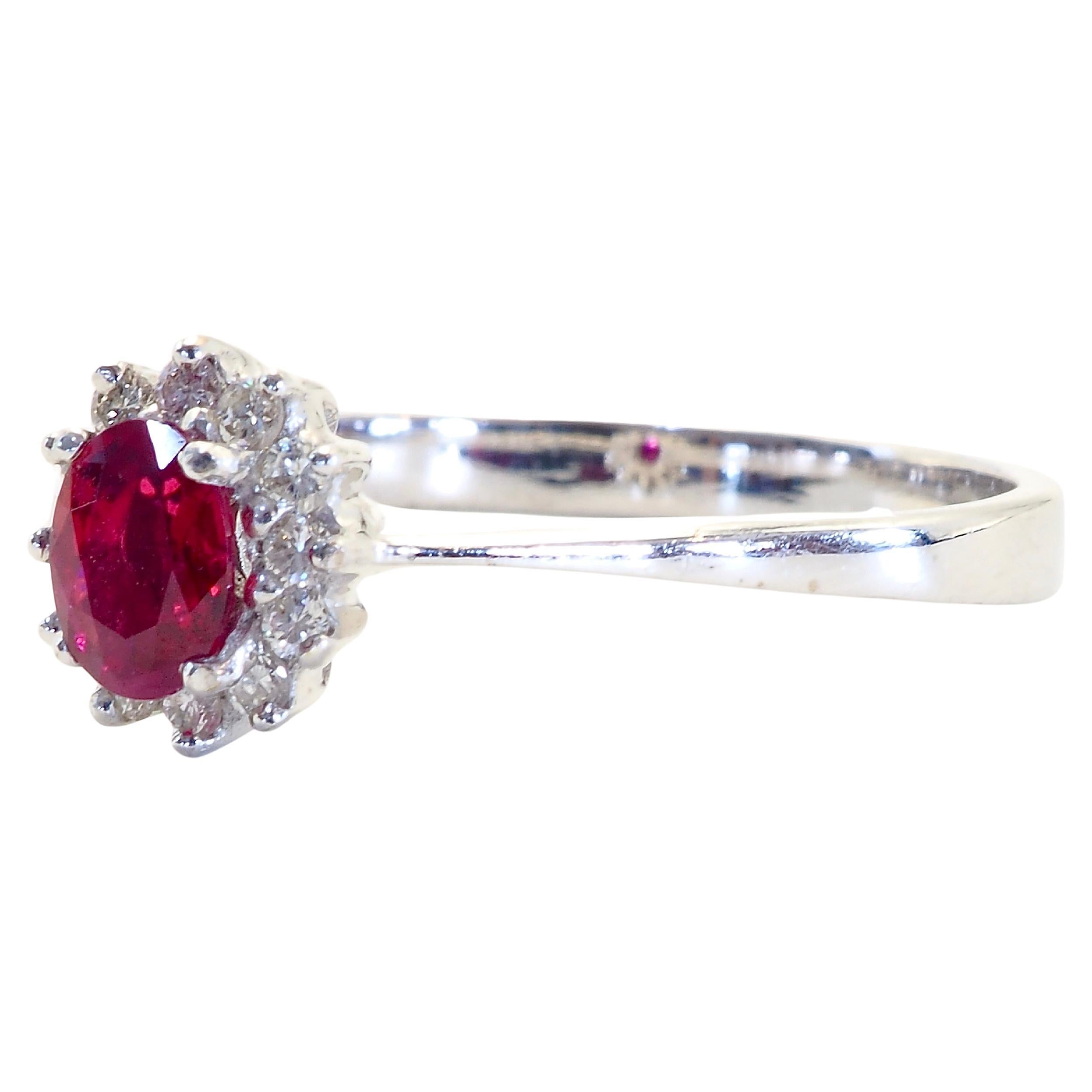 This wonderful engagement ring boasts a stunning deep red oval cut ruby. The stunning oval cut ruby is refractive which is set in the middle of brilliant round cut diamonds of good grade. It is a very clear ruby.

 Immaculate craftsmanship can be