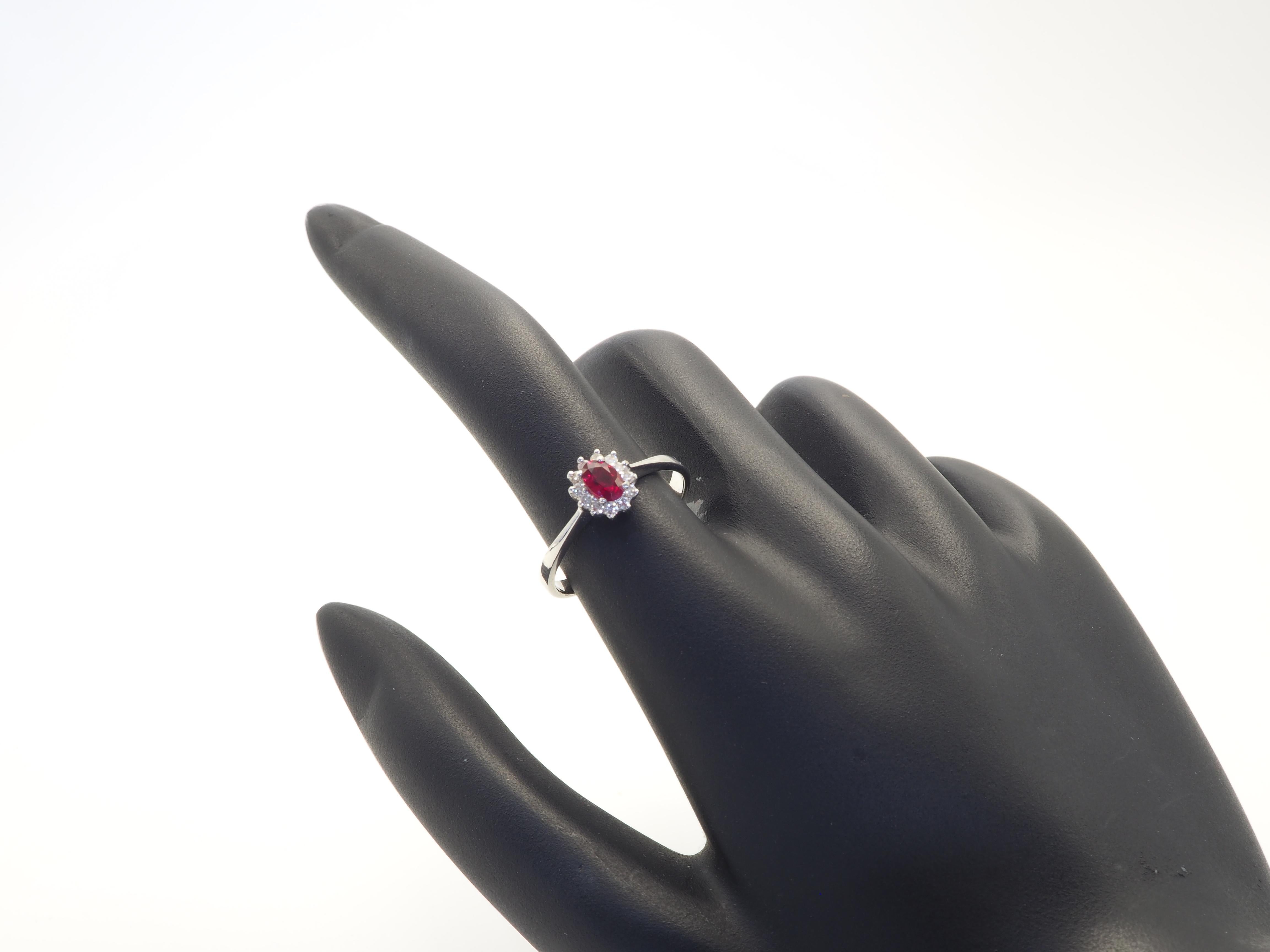 Women's 18K White Gold 0.62ct Oval Deep Red Ruby & 0.20ct Diamond Halo Ring For Sale