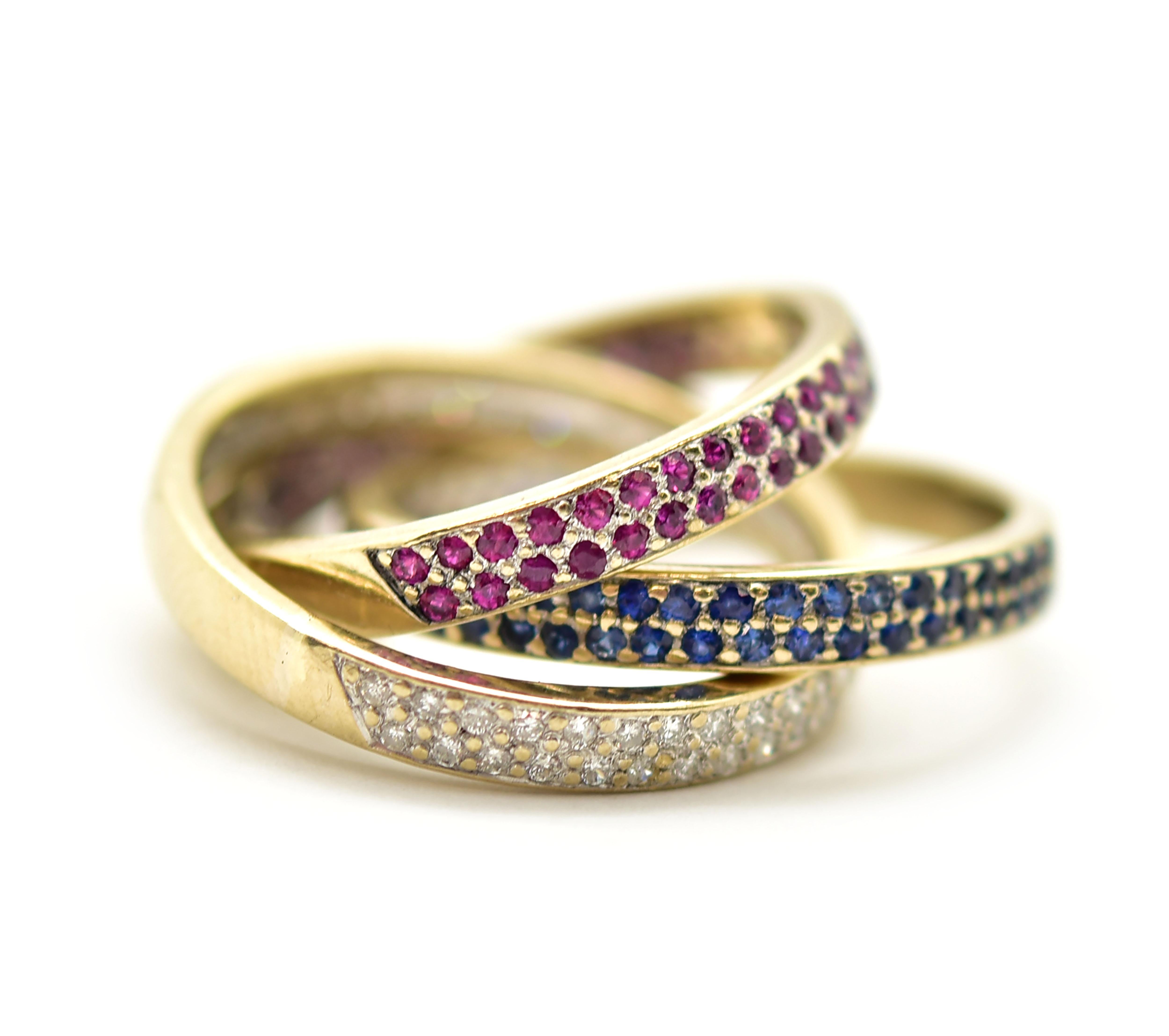 This piece of jewelry showcases extreme creativity combined with beautiful gemstones. The rings are attached to each other to create a rolling effect. Each ring is either ruby, sapphire or diamonds, each set in two rows.  The first ring is designed
