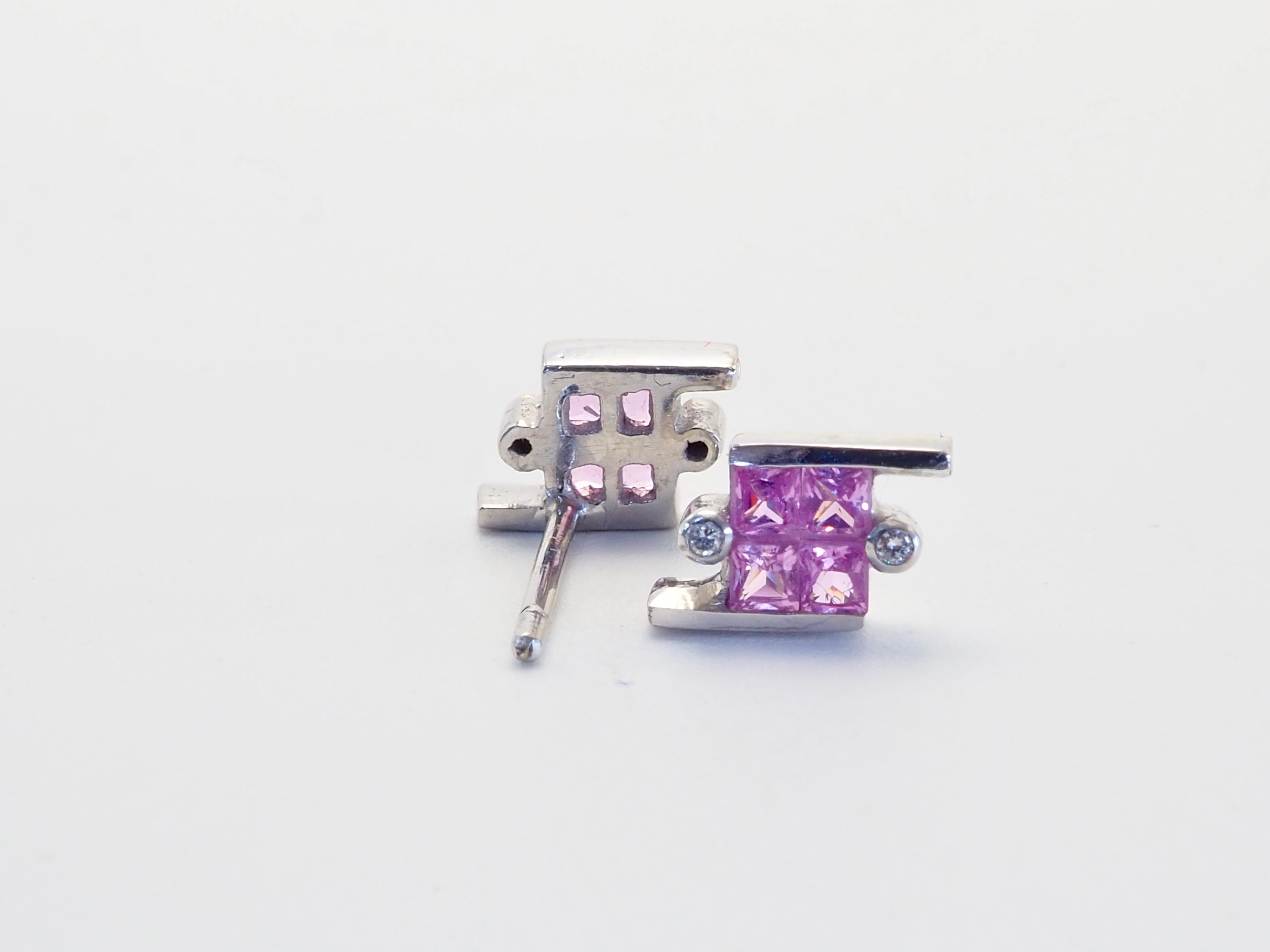 Beautiful and unique earrings made in the 1990's and has never been worn. The earrings have the unique geometric shape with channel design. There are 8 squared and colorfully saturated pink sapphires in total and therefore 4 for each ear. They are