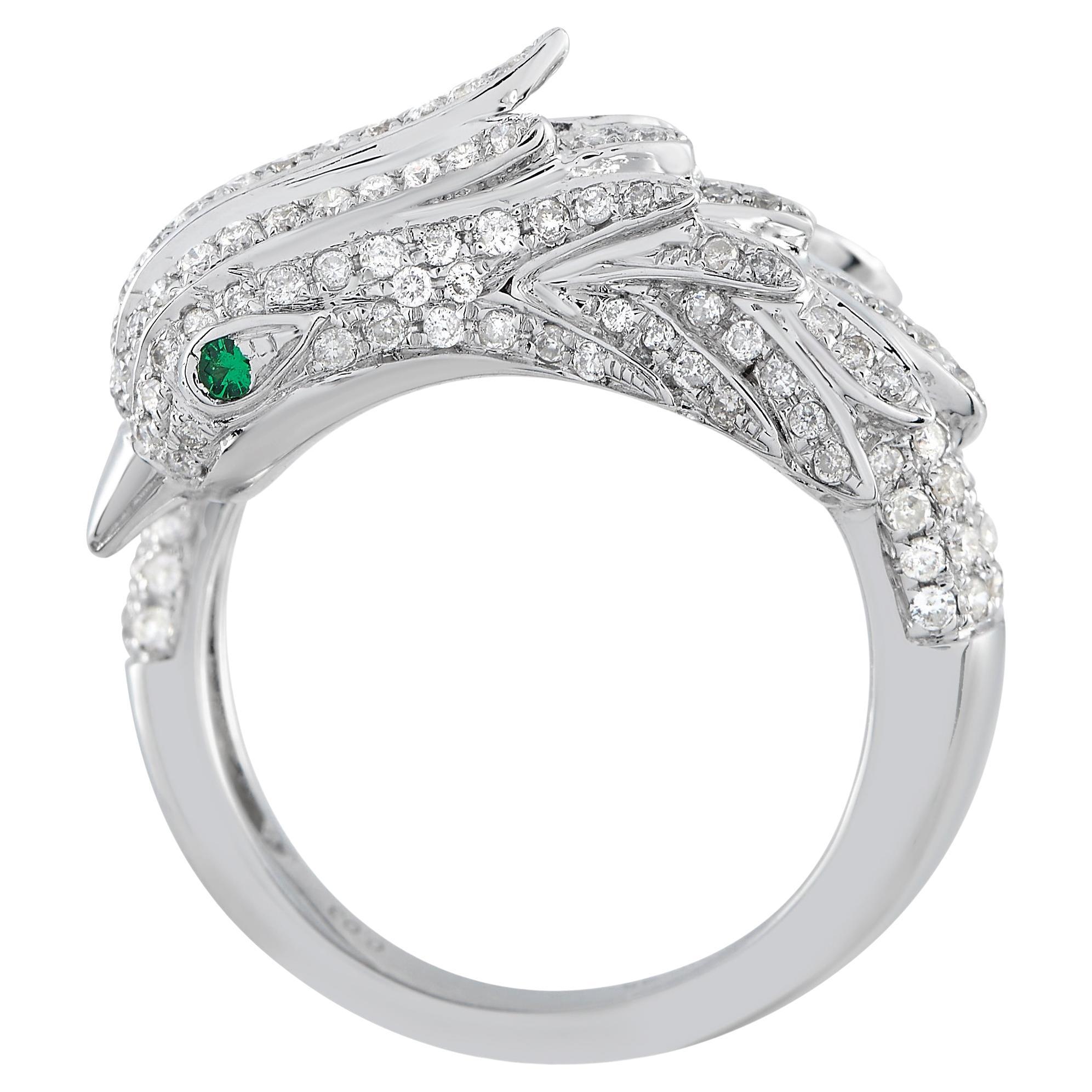 Featuring an avian motif, this ring in white gold features a bypass shank with a sculpted bird's head on one end and the tail on the other. Brilliant diamonds adorn the carved design, adding elegance to the piece. The ring's top dimensions measure